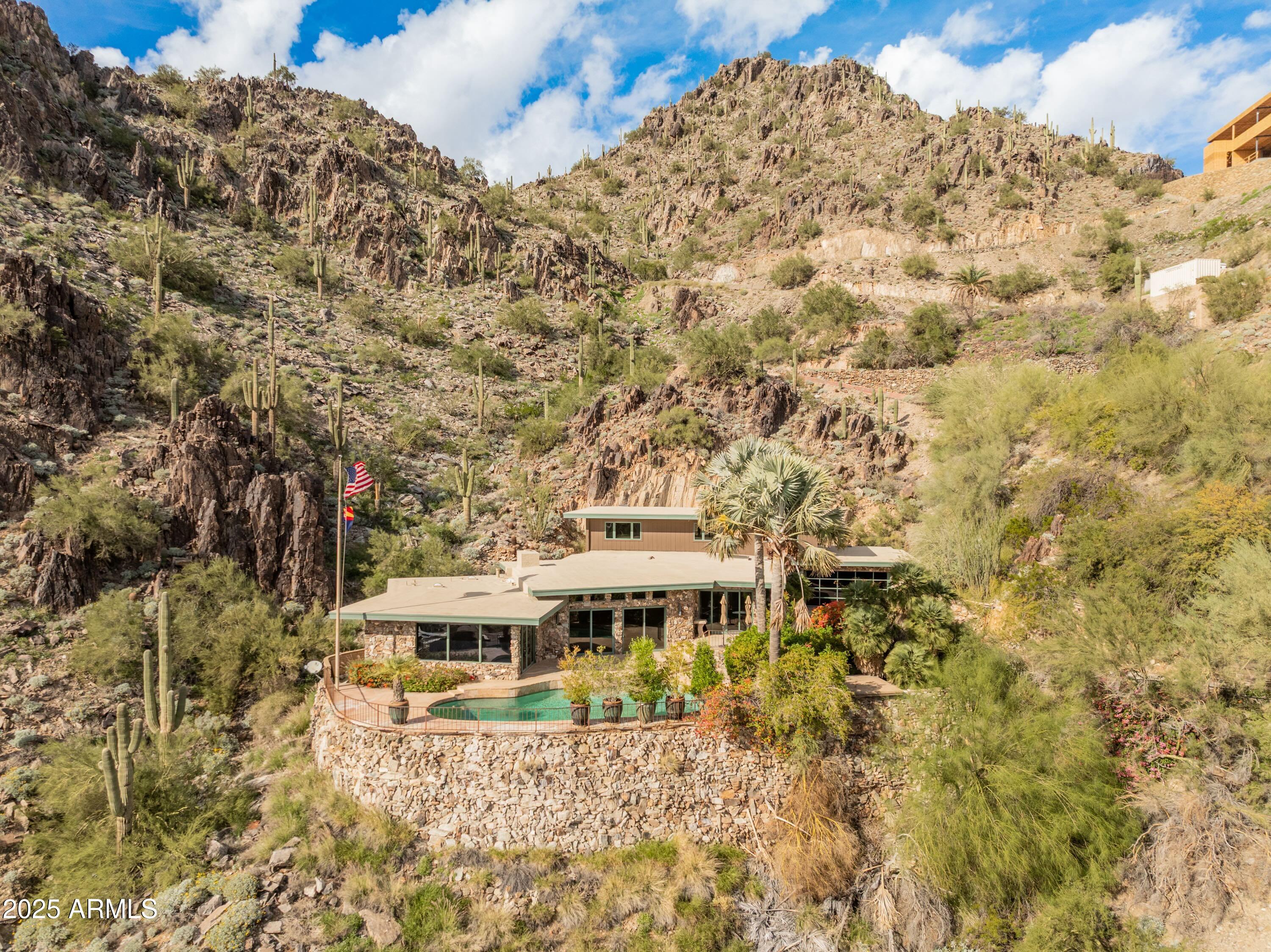 Stunning privately gated 2.3+ acre hillside estate lot on Highcliff Drive backing to the Phoenix Mountain Preserve  - one of only 4 homes sit on this elevated and premier section of Clearwater Hills. There are many possibilities from a light or full remodeling of the current (very livable) home (built by Dave Hansen) or building your new hillside resort masterpiece.  Views, privacy, and exclusivity!  Featured in Phoenix Home & Garden magazine (''Stone & Steel'').