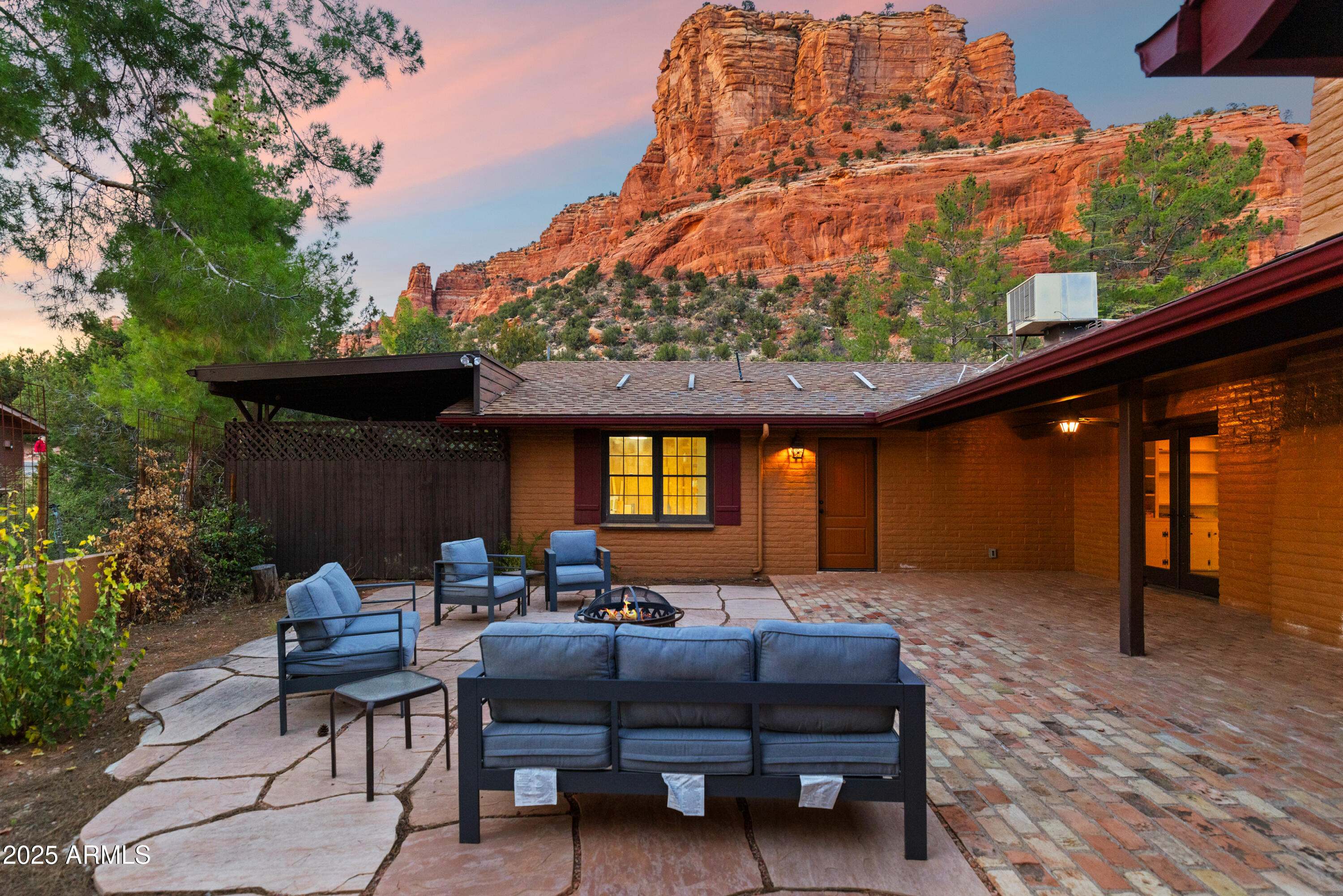Positioned on a generous double lot at the base of Castle Rock, this upgraded brick residence blends classic construction with modern enhancements. The home's original hardwood flooring sets a refined backdrop for well-proportioned living spaces, including an updated kitchen and renovated baths designed for everyday ease.

Both Guest bedrooms function as full suites, providing flexibility for long-term guests or multi-generational living. The primary suite is further enhanced by an enclosed sunroom and a recently installed five-head mini-split system for efficient climate control. The property itself is a standout. A wide canyon-style wash along the rear creates exceptional privacy, and the expansive outdoor footprint supports a range of uses from gardening and recreation to additional parking or future improvements/building. Raised beds, a storage shed, and a dedicated basketball area are already in place, with room for more. It's a rare combination of location, space, and thoughtful updates in one of the area's most desirable neighborhoods.

The oversized lot is one of this property's greatest assets. With extra parking already in place and a finished basketball court, the outdoor layout is both practical and versatile. Beyond the current improvements, the additional land offers significant flexibility for future development. Whether the next owner envisions a guest casita, studio, workshop, or expanded outdoor living, there's ample space to bring those ideas to life.