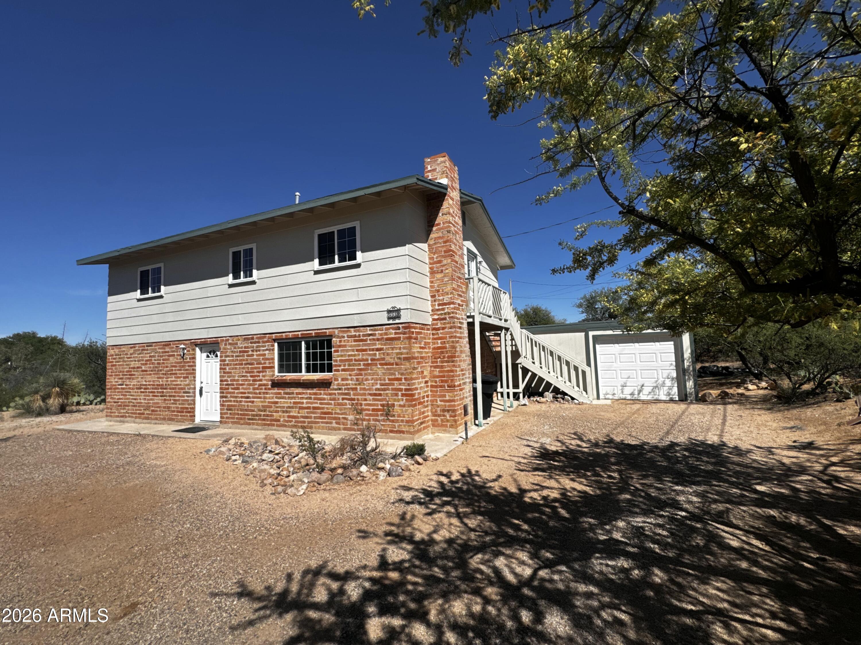 Beautifully remodeled 3-bedroom, 2.5-bath home on a spacious lot with stunning city and San Pedro River views. Features include a 1-car garage with an oversized workshop for flexible use.

The two-story layout offers a large living room, dining area, half bath, and a cozy family room with fireplace on the main level. Brick accent walls and a natural wood ceiling add warmth and character. Upstairs includes all bedrooms and full bathrooms for added privacy.

Updated kitchen and bathrooms make this home truly move-in ready.