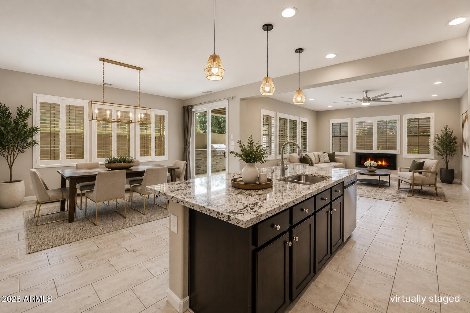 Everyone has a favorite room in this home... and almost nobody picks the same one.

Some fall in love with the backyard, where evenings revolve around the built-in outdoor kitchen, fire feature, fountain and covered patio. Others can't stop talking about the incredible custom dressing room-style closet in the primary suite.

But what really makes this home stand apart is the way it lives.

A bedroom and full bath on the main level offer flexibility for guests, a home office or multigenerational living. Upstairs, the loft separates two private bedroom suites, creating privacy that's surprisingly hard to find.

At the center of it all is a beautifully designed kitchen featuring granite countertops, stainless steel appliances, abundant cabinetry, a step-in pantry, and an oversized island keeps everyone connected, whether you're hosting friends or enjoying a quiet night at home.

Located inside the gated Villa del Lago community in Ocotillo, you'll enjoy scenic lakes, walking paths, a community pool, parks, golf, shopping, dining, Intel and convenient access to the Price Corridor.

The only question is... which room will be your favorite?