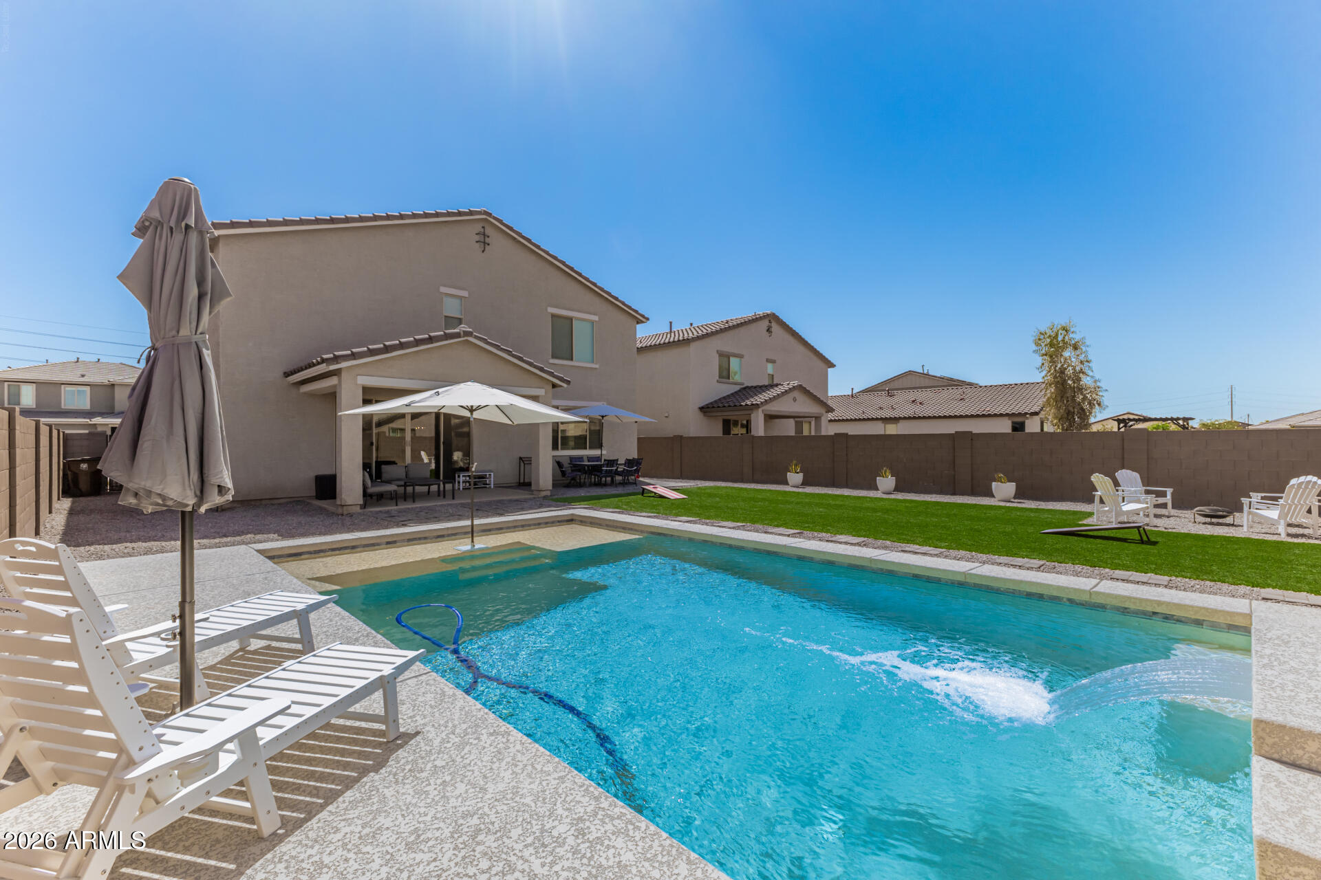 Highly upgraded 2021-built Richmond American home with POOL!  A rare find with 6 bedrooms PLUS a loft, so there is plenty of space for everyone.  The luxurious kitchen features crisp white cabinets, quartz counters with a center island sink, and stainless appliances including a gas range and fridge.  The washer/dryer set also convey. 12x24 tile flooring and black matte hardware & lighting for a modern feel.  Spacious master bedroom and a HUGE walk-in closet. Are your In-laws coming to visit?  There is a bedroom and full bath downstairs so they can have their own private space.  The low-maintenance backyard is perfect for entertaining, with a sparkling Pebble-Tec pool and large area of artificial grass.  See this amazing home today!