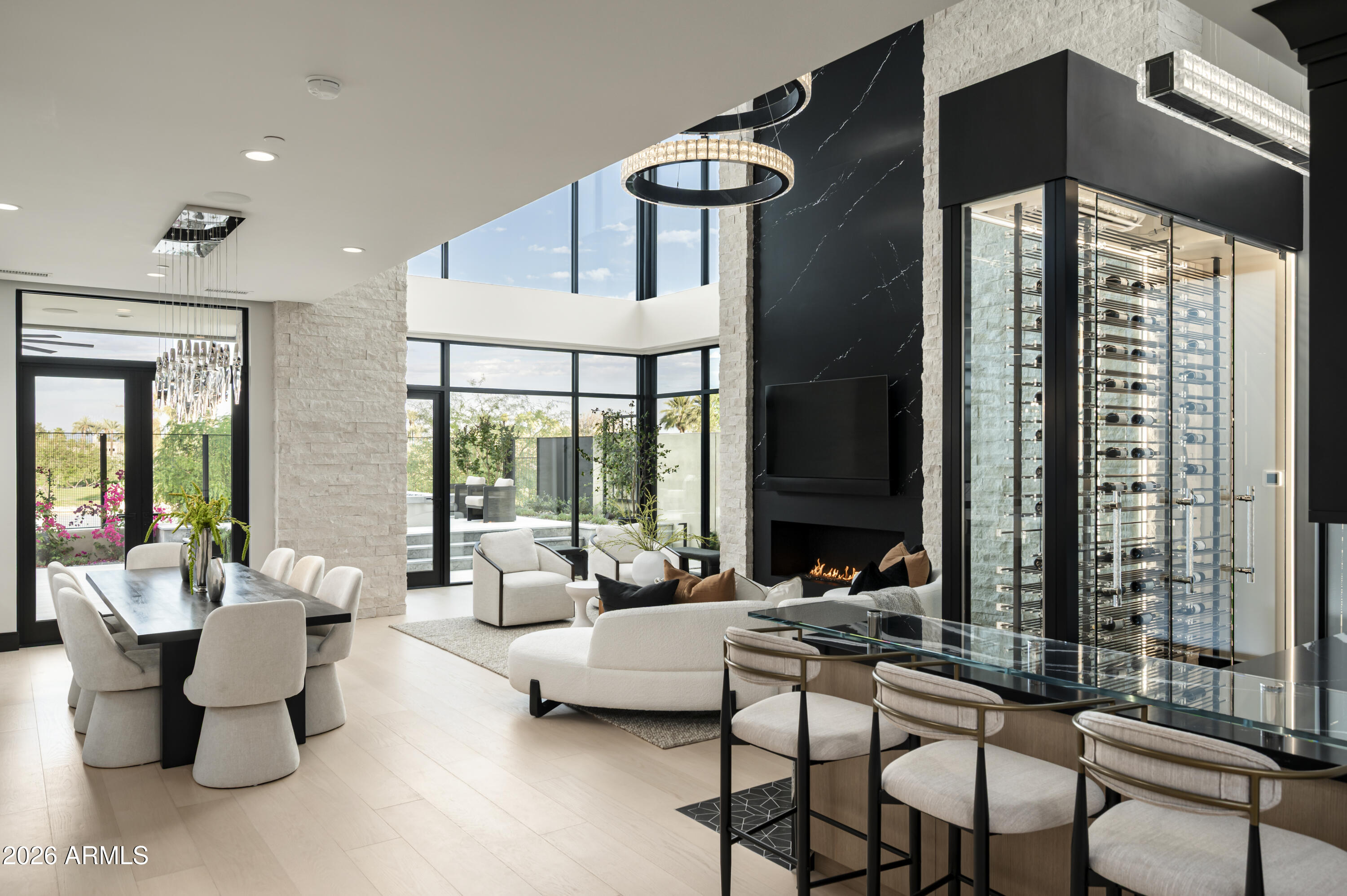 Tucked at the base of Camelback Mountain within the exclusive Ascent at The Phoenician, this newly constructed residence offers a sophisticated blend of contemporary design, thoughtful functionality, and resort-style living. Built by Cullum Homes, this customized floor plan spans 5,560SF, featuring 3 bedrooms, 3.5 baths, custom office, exercise room, loft area and three car garage with air conditioned storage. 
Designed for seamless indoor-outdoor living, the main level is anchored by a striking great room with expansive pocket doors that open to covered patios and frame sweeping mountain and golf course views. The chef's kitchen is beautifully appointed with Sub-Zero and Wolf appliances, complemented by a discreet butler's pantry/back kitchen that enhances both everyday living and effortless entertaining. 
A sculptural floating staircase and private elevator connect the home's thoughtfully designed spaces, including an upper-level loft and view terrace. The primary suite offers a serene retreat, while additional en-suite bedrooms provide comfort and privacy for guests. A dedicated in-residence fitness room further elevates the home's livability. 
Extensively upgraded throughout, the residence showcases refined finishes, abundant storage, and a rare air-conditioned garage with additional climate-controlled storage--an exceptional feature for the discerning collector. 
Residents enjoy a premier lock-and-leave lifestyle with access to exclusive community amenities and the option to experience the world-class offerings of The Phoenician, just moments away.