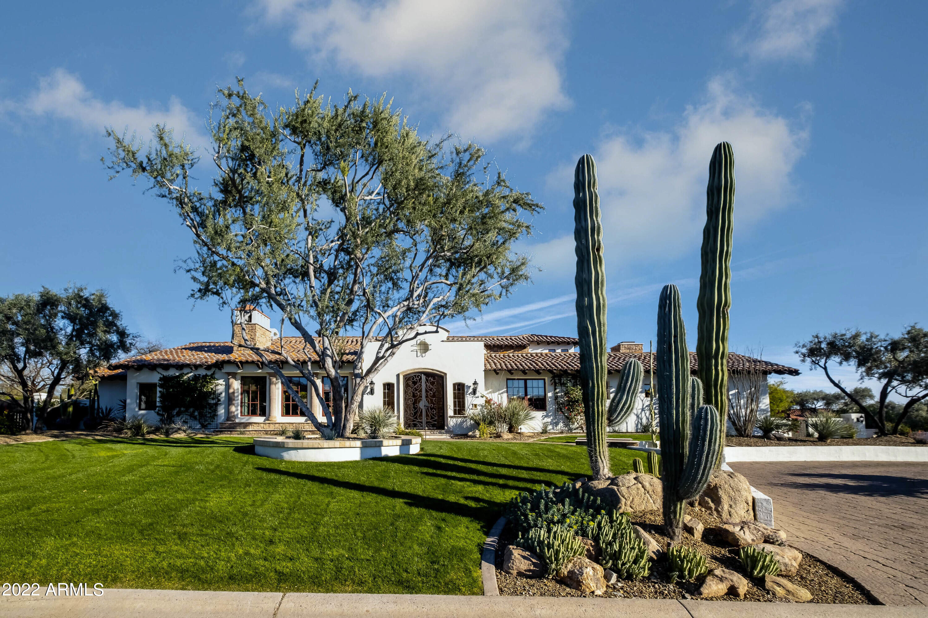 This beautifully updated Paradise Valley home has everything you're looking for!  The focal point is the grand great room featuring impressive reclaimed trusses, beams and historic wood floors.  The massive fireplace is a statement.  Beautiful chef's kitchen features top of the line appliances, Vadara Quartz countertops and a massive island.  The master suite has every couples dream of separate his AND hers bathrooms/closets, his with steam, hers with relaxing air therapy tub!  Four additional split ensuite bedrooms/bathrooms. The wet bar has a doorway to a beautiful climate controlled wine cellar and tasting room.  Versatile theatre/bonus room with drop down movie screen, expansive yard with Ramada and beautiful pool/spa.  5 fireplaces!  Garage space for up to 5 cars.  Fireproof safe room Amazing views of Camelback Mt and Piestewa Peak.  City light views from upstairs Guest suite.  Walking distance to great hiking trails and The Hermosa Inn!