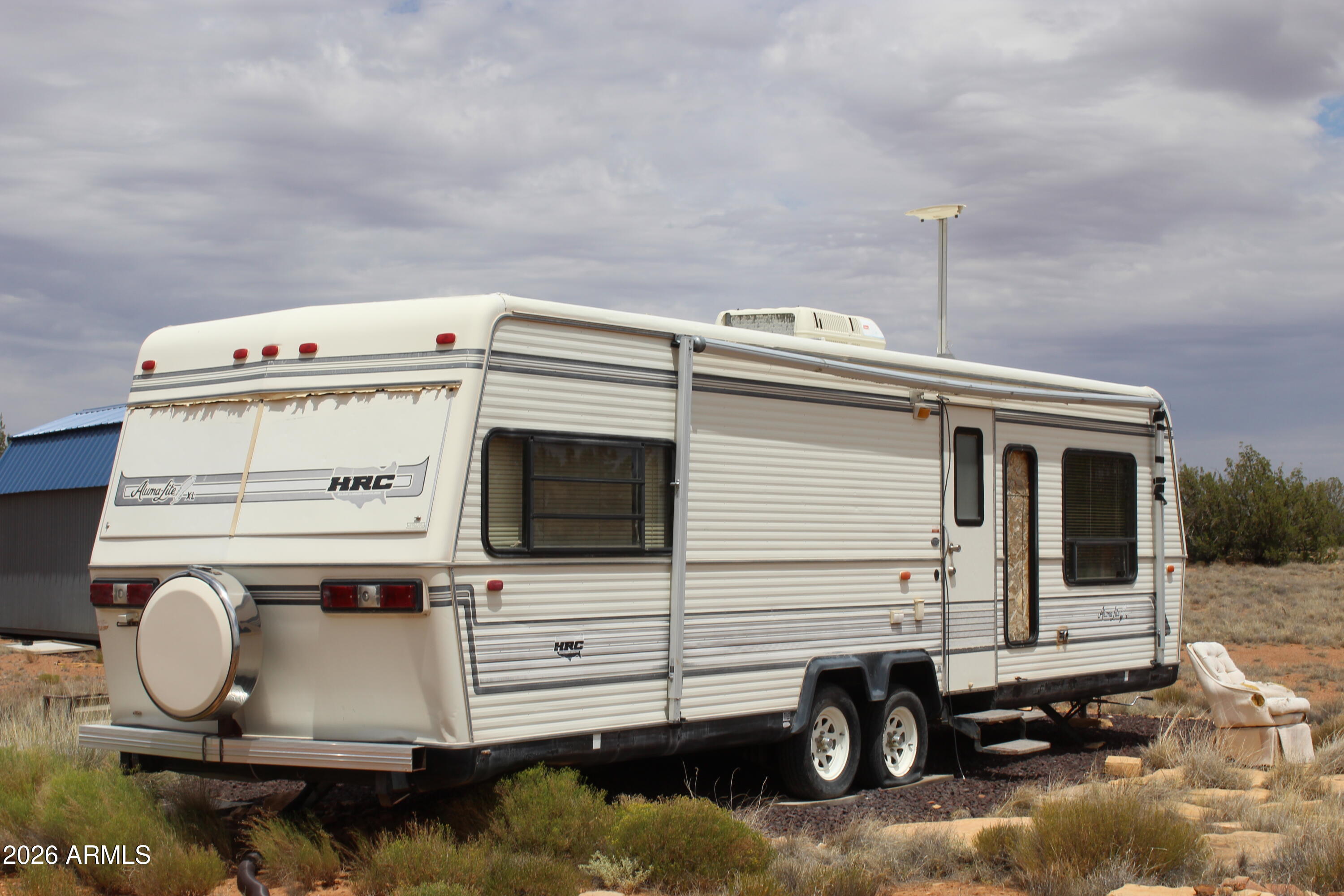 If you're looking for acreage that has 1600-foot frontage on Black Canyon, look no further. Besides the 43 acres there is a 10x20 Dutch Gable Graceland Storage shed, a New 1000 gal 2 Bedroom septic system, with a 29 foot Aluma Craft Travel Trailer & a water storage tank with Gravity flow to the Trailer & surrounded by 8 acres of wire fencing. Elk, Deer & other wildlife are some of the wildlife that roam the area. Water is provided through your HOA along with road maintenance and street signs. You can if you so choose to drill your own well. Owner May Carry. Come on up and enjoy the clean fresh air of the White Mountains & get away from the heat & enjoy 4 seasons.