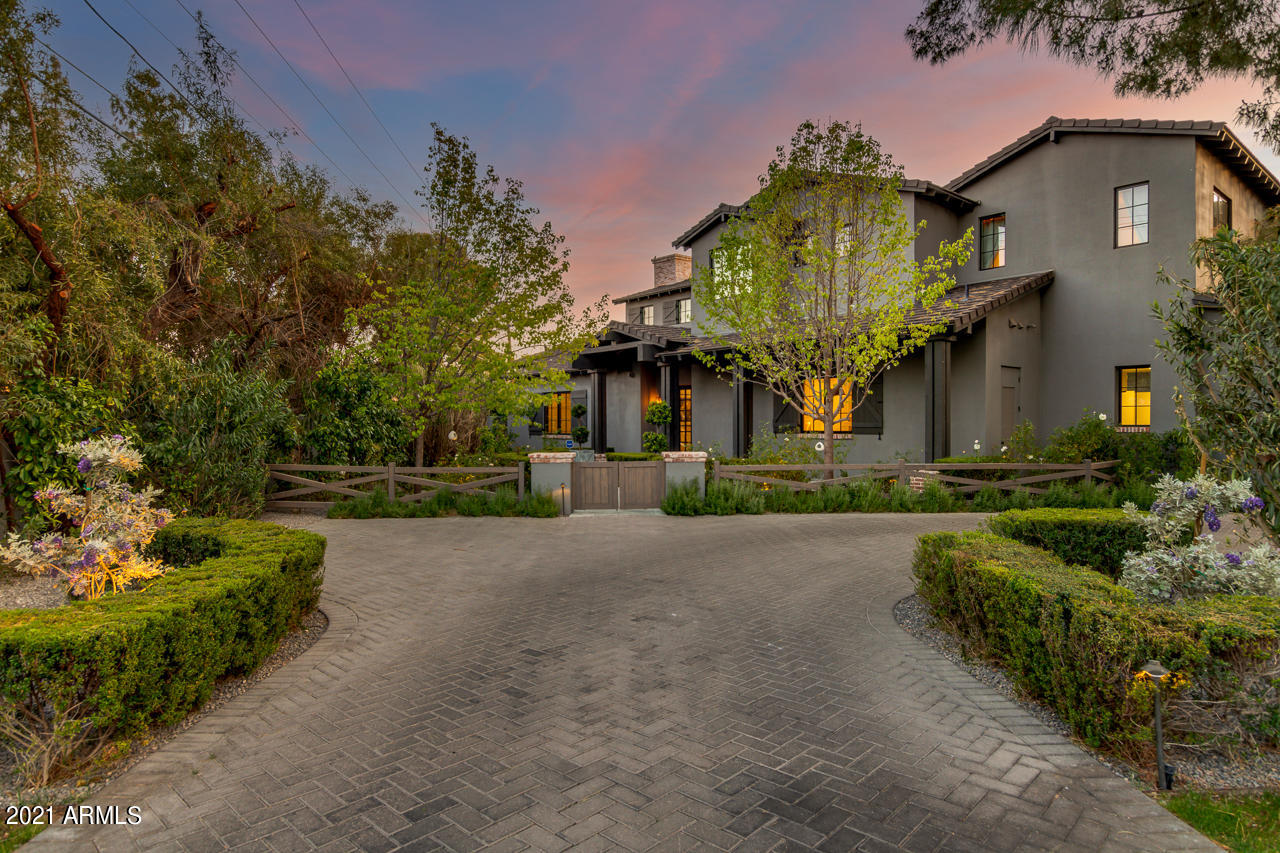 The very definition of sophistication and style. This one-of-a-kind estate, nestled on the prestigious Arizona Country Club redefines what luxury living is about. 

A stunning garden pathway guides you to this special residence featuring 4 bedrooms / 4 baths with an additional 5th bedroom or office. This modern farmhouse exudes casual comfort with understated luxurious features such as French oak wood flooring, Rysso Peters custom millwork, reclaimed wood beams, soapstone counters and more. Exceptional livability with a functional floor plan and the perfect amount of natural light. Living room features a soaring 25 foot ceiling, an oversized fireplace and a whole wall library and art showcase, custom built by renowned design firm Paul Rene and featured in Phoenix Home and Garden Magazine Well-appointed master retreat with superb finishes, large walk-in closet and resort-style bath. From here, open up the french doors to reveal a quaint walled garden complete with a spa and an outdoor TV for maximum relaxation. Upstairs, a tastefully designed loft area is perfect for a cozy retreat or children's sanctuary. Three additional bedrooms round out the second floor, two connected by an oversized bath and one en-suite.

This home is a marvel of modern technology with a data-center grade, air-conditioned server room with whole-whose audio, video, Sonos, Apple TV and automation system that allows for effortless control of every aspect of the house. Use your phone or conveniently located touch screen controls to manage thermostats, gate, pool, security cameras or create special scenes for one-touch convenience. Full security system with DVR recording, advanced pet-friendly sensors all connected via Google security.  

The back yard boasts unparalleled views of Arizona Country Club's course and amazing Arizona sunsets. The views come alive even more at night making this home an exceptional space to entertain. Additional outdoor features are bluestone patios, built-in BBQ, Green Egg, Kegerator, bistro lights and a large outdoor TV and Refined Gardens designed landscaping.

The three car garage features custom wall-to-ceiling cabinetry and a dedicated professionally-installed EV 240V car charger. Brand new (less than one month old) top-of-the-line tankless water heaters and a 10 year-warrantied, zero-maintenance whole house water conditioner. Every inch of the house is professionally maintained and ready for the next owner to enjoy...