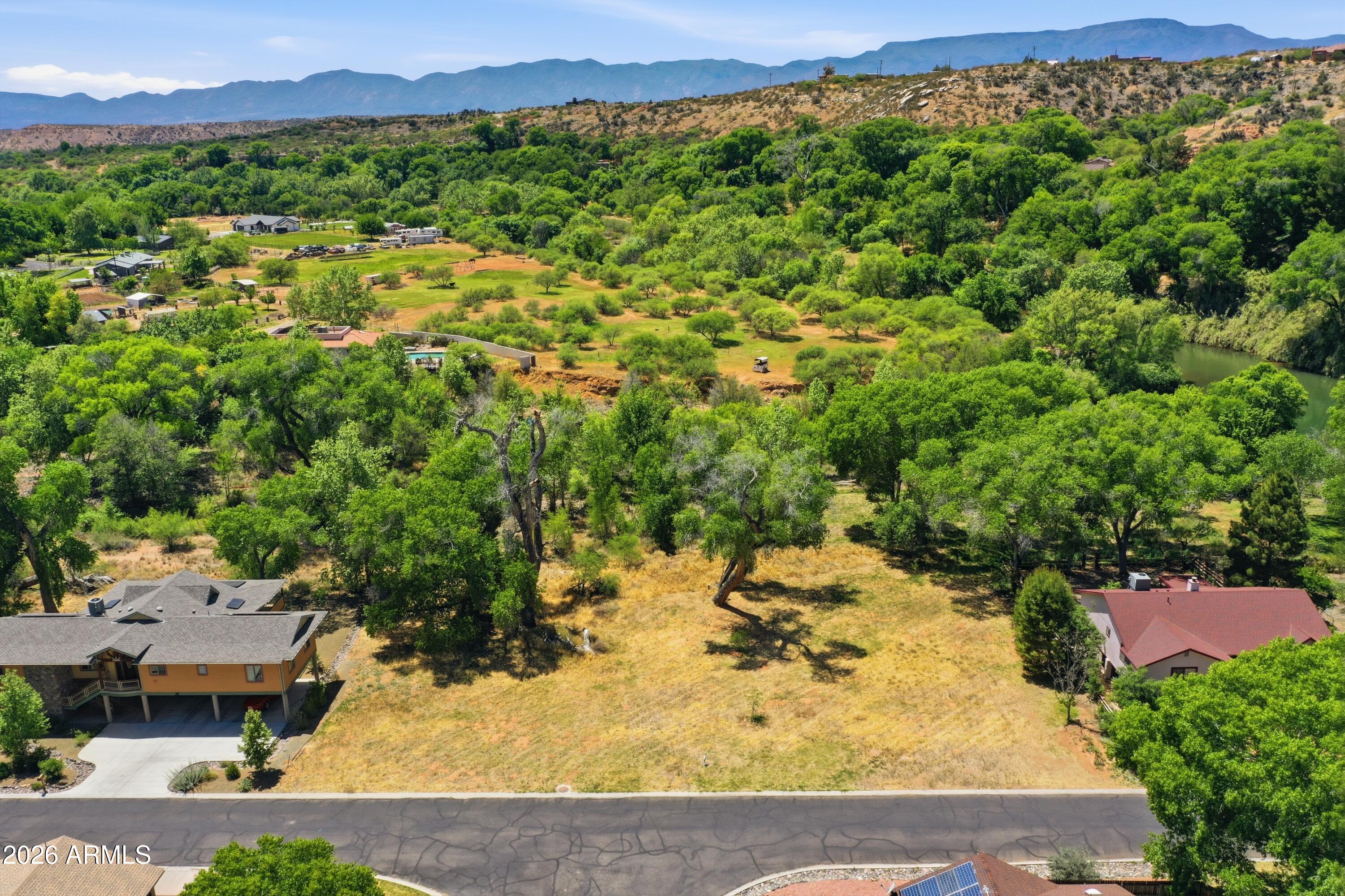Ready to build Oak Creek Valley beauty, this rare homesite offers a spectacular opportunity at the confluence of Oak Creek and Spring Creek. Residents of this peaceful gated community enjoy exclusive creek access, along with clubhouse, pool, tennis/pickleball courts, manicured parks, scenic trails, and private float launch. Ideally located steps from the community park and creek access, enjoy fishing, swimming and abundant wildlife. Sellers have completed nearly all the groundwork to bring a stunning modern home to life, saving time, money, and uncertainty. Included in sale are topography/soil testing, survey, grading report, floodway report, and custom building plans. With few vacant lots in this unique and sought after community, opportunities like this are increasingly limited.