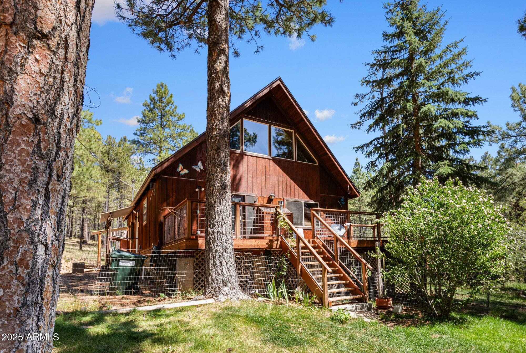 Secluded rustic cabin on the coveted south side of Forest Lakes Estates.

Tucked away at the end of a quiet cul-de-sac on the highly sought-after South Side of Forest Lakes Estates, this charming 3-bedroom, 2-bath cabin offers the perfect blend of rustic character, modern comfort, and exceptional privacy. Set on just over an acre of towering pines, it's the ideal retreat from the hustle and heat of city life.

Inside, the open-concept layout welcomes you with a spacious great room featuring soaring vaulted ceilings, warm wood-slat paneling, and dramatic dark wood beams that add both charm and architectural interest. The kitchen, which opens directly to the great room, is designed with ample counter space and cabinetry--perfect for meal prep while still staying connected to family and guests. Whether you're cooking up breakfast or entertaining a crowd, the space is both functional and social.

An elevated front porch provides a serene perch to take in stunning views of the property and the surrounding forest, where you can regularly spot deer, elk, and other wildlife. Downstairs, the guest bathroom includes a separate stand-alone shower and an oversized spa tub for the ultimate in relaxation. Upstairs, the private primary suite features a walk-in closet with a built-in safe and an ensuite bathroom with a shower/tub combo.

The beautifully wooded grounds are dotted with garden beds ready for planting, and a chicken coop is already in place for those interested in raising hens. Additional features include a separate storage shed and a stand-alone, oversized heated garage ideal for a workshop, storing off-road toys, or tackling projects year-round.

Located just a scenic two-hour drive from Phoenix, Forest Lakes offers a refreshing escape with average summer temperatures in the mid-70s. Known for its strong sense of community and family-friendly events, it's a place where you can truly unwind and reconnect with nature.

Whether you're looking for a weekend escape or a full-time residence, this secluded cabin checks all the boxes. Come experience the peace, cooler climate, and endless outdoor recreation that make Forest Lakes such a treasured mountain destination.

*Please note that one or more photos in this listing have been virtually staged to illustrate furniture layout options. The home is currently vacant and ready for your personal touch.