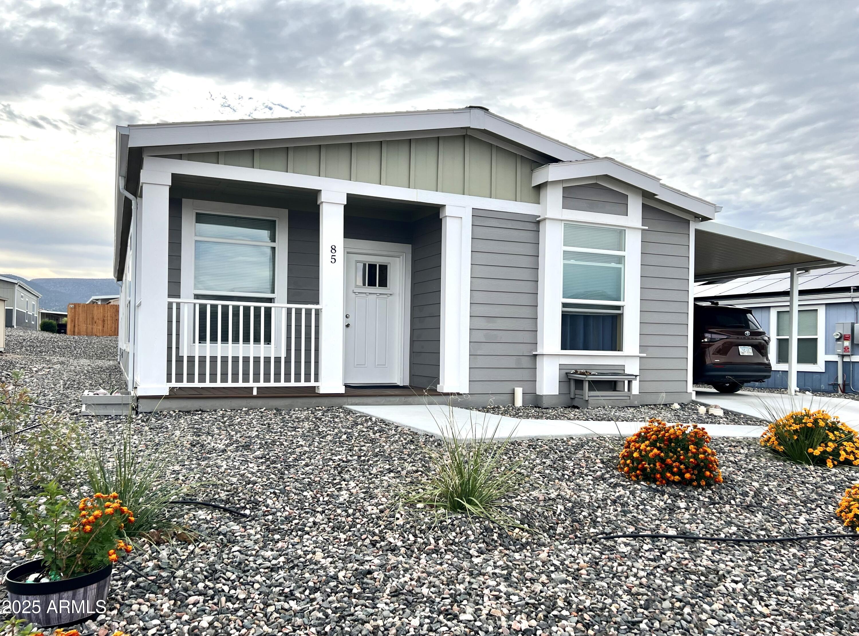 NEW....PRICE REDUCTION AND UPDATE!! Sellers have purchased a backyard fence for the property. The fence shall be included in the sale, and will be installed in the next two weeks. Welcome to this well-maintained 3-bedroom, 2-bath Champion model manufactured home located in Verde Ranch Estates--an all-ages, gated community in the heart of Camp Verde, Arizona. Offering 1,423 sq ft of well-designed living space, this home delivers a balance of comfort, practicality, and easy living that appeals to first-time buyers, retirees, or anyone seeking a simpler, low-maintenance lifestyle. 

Inside, the open layout creates a natural flow between the living room, dining area, and kitchen, allowing light to brighten the space throughout the day. The kitchen features generous cabinetry, stainless steel appliances, efficient workspace, and modern touches that make daily routines convenient and enjoyable. 

The primary bedroom includes an en-suite bath, offering privacy and comfort, while the additional bedrooms provide flexibility for guests, a home office, or hobbies. Thoughtful upgrades and updates throughout the home enhance both style and functionality, contributing to its well-cared-for condition. 

A covered carport adds year-round convenience, and the low-maintenance exterior means you can spend more time enjoying the community's amenities and less time on upkeep. And that's where this property truly shines - Verde Ranch Estates offers a lifestyle that feels like a blend of comfort, connection, and recreation. 

Within the gated community, residents enjoy access to an impressive selection of amenities: a welcoming clubhouse, outdoor pool, spa, fitness center, game room, pickleball courts, dog run, playground, and beautifully maintained common areas. Whether you prefer relaxing in the spa, staying active on the courts, enjoying social gatherings, or taking morning walks around the neighborhood, this community makes it easy to settle into a daily rhythm that feels both peaceful and engaging. 

Conveniently located near shopping, dining, medical services, and outdoor attractions throughout the Verde Valley, the home offers easy access to everything you need while maintaining a sense of tranquility. With its thoughtful layout, well-kept condition, and access to resort-style amenities, this home presents an appealing opportunity for buyers wanting comfort, simplicity, and a strong sense of community.