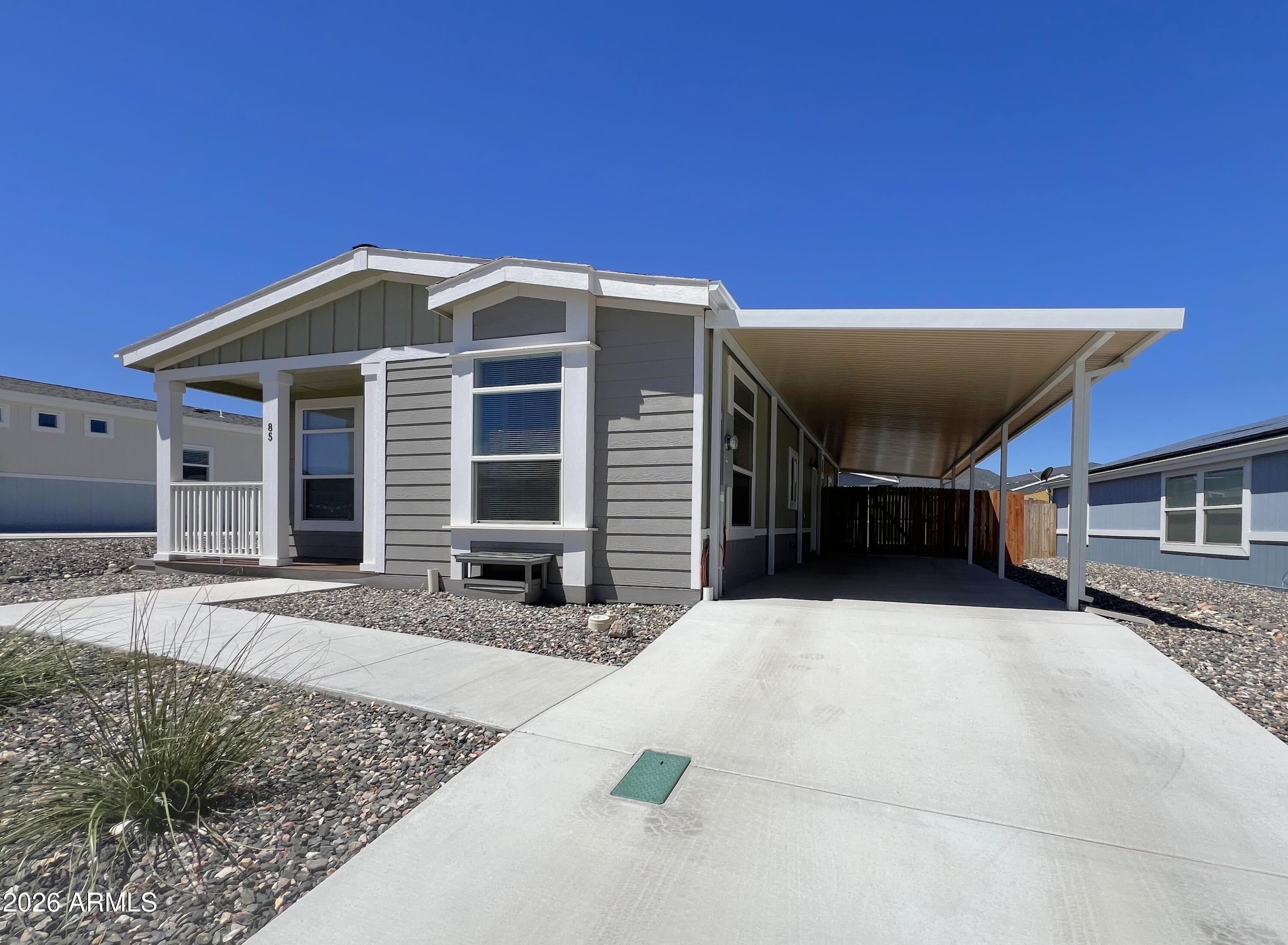 NEW....BACKYARD FENCE RECENTLY INSTALLED. Welcome to this well-maintained 3-bedroom, 2-bath Champion model manufactured home located in Verde Ranch Estates--an all-ages, gated community in the heart of Camp Verde, Arizona. Offering 1,423 sq ft of well-designed living space, this home delivers a balance of comfort, practicality, and easy living that appeals to first-time buyers, retirees, or anyone seeking a simpler, low-maintenance lifestyle. 

Inside, the open layout creates a natural flow between the living room, dining area, and kitchen, allowing light to brighten the space throughout the day. The kitchen features generous cabinetry, stainless steel appliances, efficient workspace, and modern touches that make daily routines convenient and enjoyable. 

The primary bedroom includes an en-suite bath, offering privacy and comfort, while the additional bedrooms provide flexibility for guests, a home office, or hobbies. Thoughtful upgrades and updates throughout the home enhance both style and functionality, contributing to its well-cared-for condition. 

With a brand-new backyard fence, a covered carport, and a low-maintenance exterior, you'll have more time to enjoy the community amenities and less time worrying about upkeep. That's where this property truly stands out--Verde Ranch Estates offers a lifestyle that perfectly blends comfort, connection, and recreation. 

Within the gated community, residents enjoy access to an impressive selection of amenities: a welcoming clubhouse, outdoor pool, spa, fitness center, game room, pickleball courts, dog run, playground, and beautifully maintained common areas. Whether you prefer relaxing in the spa, staying active on the courts, enjoying social gatherings, or taking morning walks around the neighborhood, this community makes it easy to settle into a daily rhythm that feels both peaceful and engaging. 

Conveniently located near shopping, dining, medical services, and outdoor attractions throughout the Verde Valley, the home offers easy access to everything you need while maintaining a sense of tranquility. With its thoughtful layout, well-kept condition, and access to resort-style amenities, this home presents an appealing opportunity for buyers wanting comfort, simplicity, and a strong sense of community.