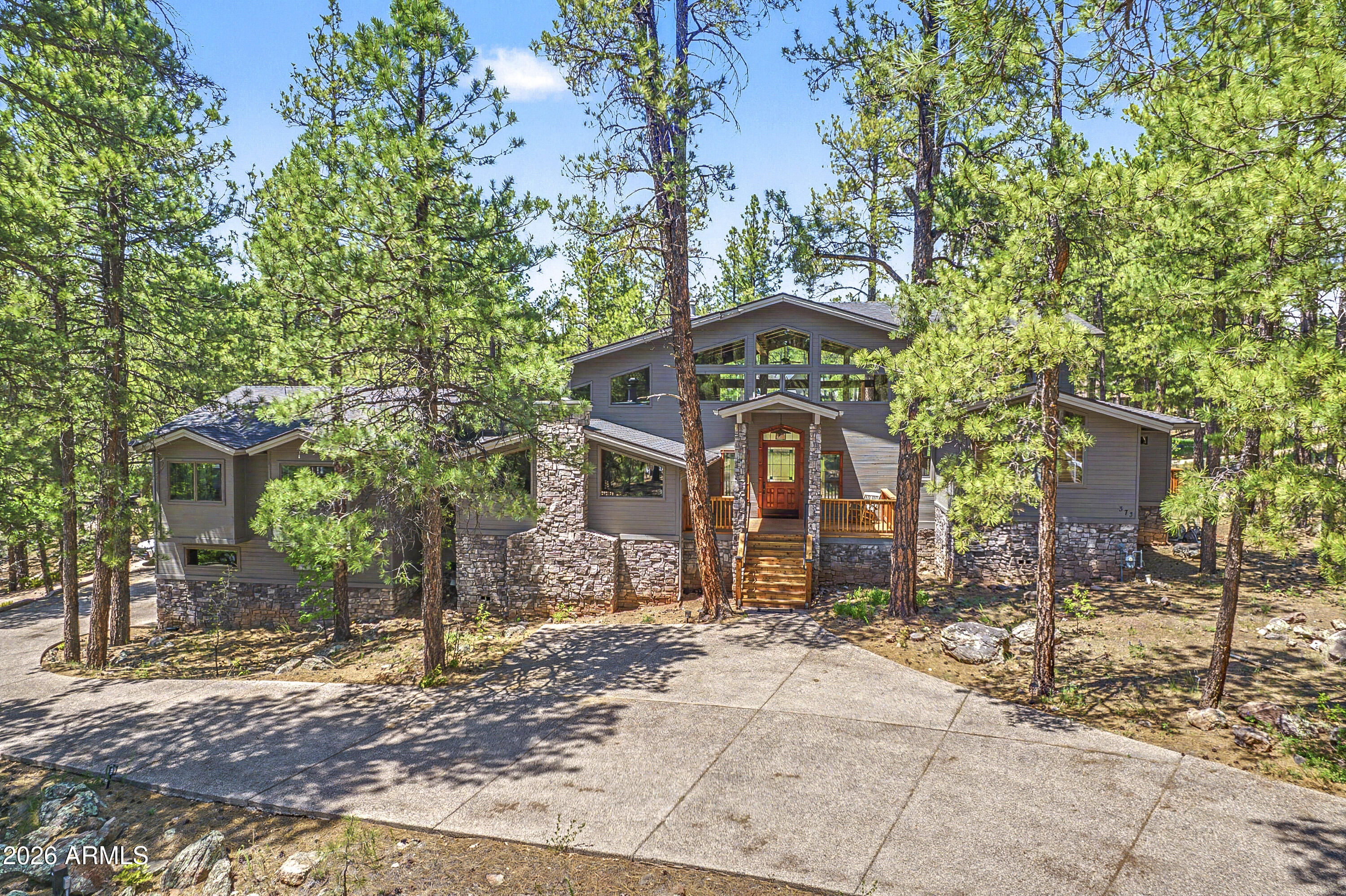 Spectacular Forest Highlands home with amazing space situated perfectly on a heavily treed corner lot overlooking the 13th hole of the Canyon Golf Course at Forest Highlands!   Expansive Great Room with cathedral ceilings, large bonus room/2nd family room, a dedicated office with Fireplace and built in cabinetry, Chef's kitchen, 5 bedrooms, of which 2 are Master Suites and multiple decks.  Top it off with central A/C and a 3-car garage and you've got the home you've been waiting for!