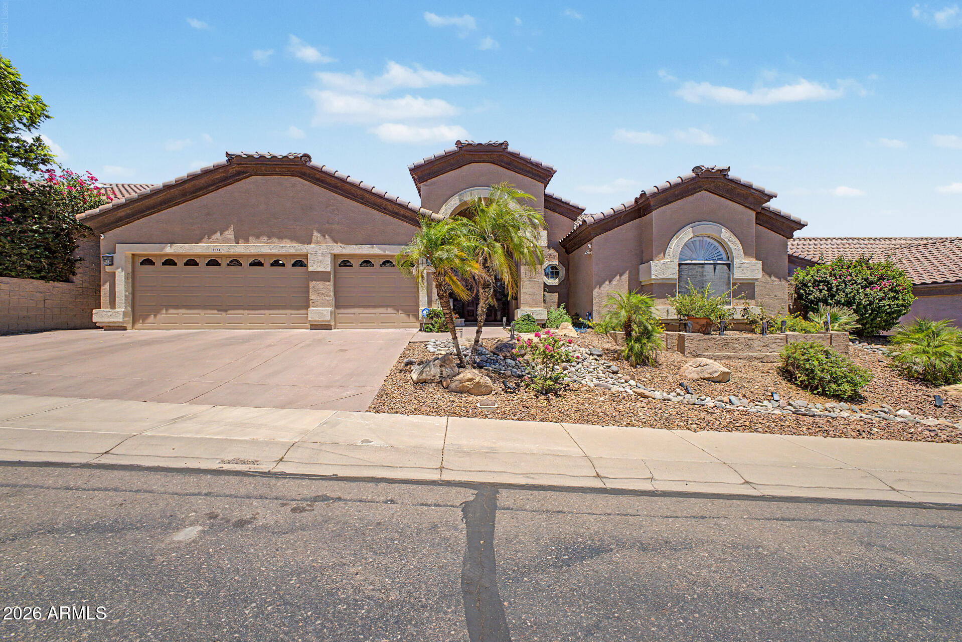 Your dream home is finally here! Gorgeous Mountain Views! This stunning residence features a 3-car garage and a low-maintenance desert landscape for excellent curb appeal. Fall in love with the captivating open layout with soaring vaulted ceilings, skylights for abundant natural light, shutters, durable tile flooring, and an inviting fireplace. The spotless chef's kitchen comes with granite counters, ample maple cabinetry with crown molding, a mosaic tile backsplash, stainless steel appliances, a walk-in pantry, and an island with a breakfast bar. The primary suite boasts soft carpeting, shutters, a sitting nook, an ensuite with double vanities, a jetted tub, and a walk-in closet. Imagine enchanting evenings in the lovely backyard