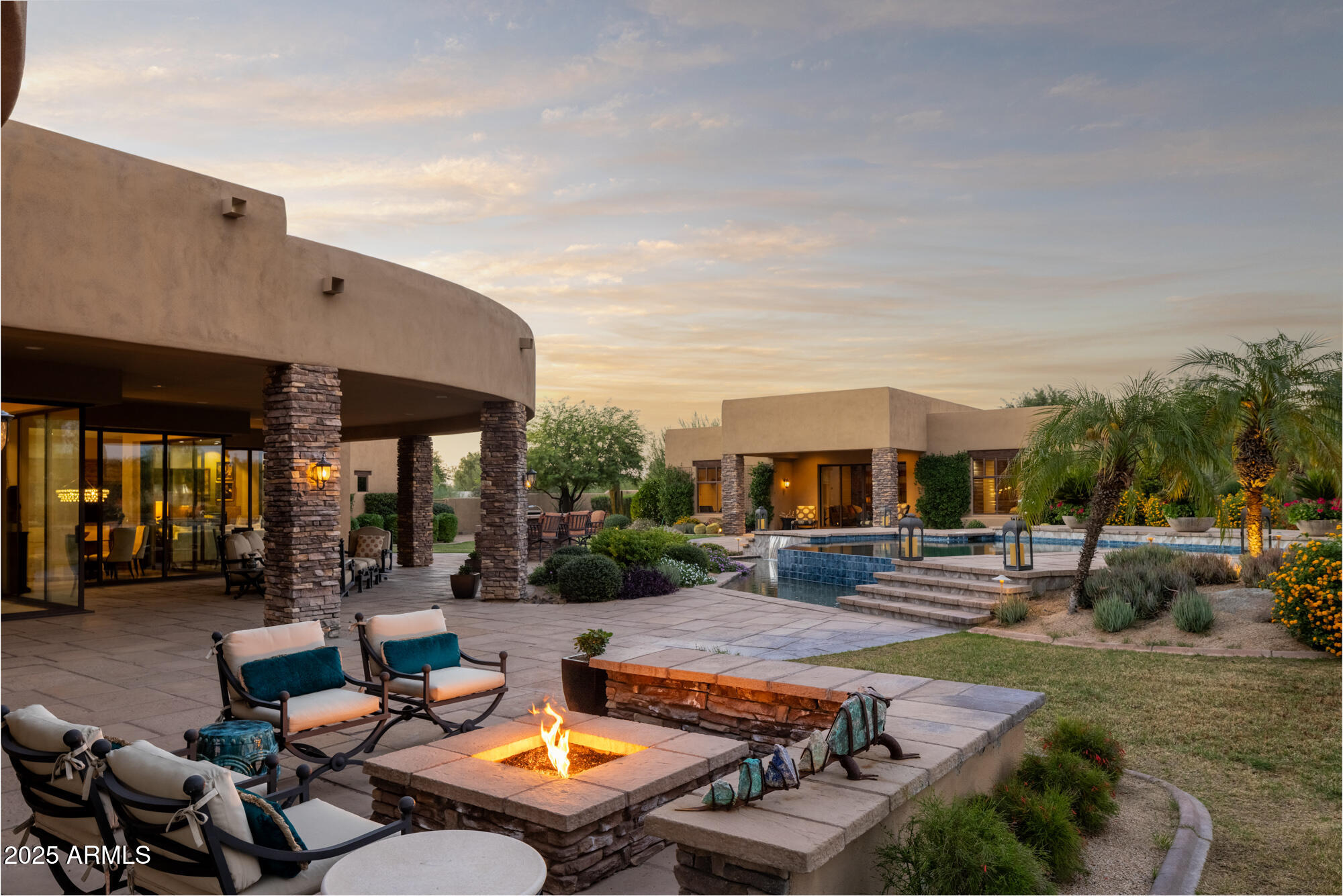 Experience the epitome of North Scottsdale luxury living on this secluded and highly coveted two-plus-acre estate surrounded by captivating views of Pinnacle Peak, the McDowell Mountain range, and beyond.  Located within a privately gated enclave, this residence is designed for effortless one-level living and is complemented by a detached full guest house with bedroom, kitchen and office/study.  The setting includes an extraordinary outdoor environment the rivals the refined interior finishes. Truly, no expense has been spared.
Inside, the main residence features three private guest suites, an inviting office or dedicated card room and expansive sliding glass walls that seamlessly blend indoor and outdoor spaces. Cooks will love the Chef's kitchen with modern, top-of-the-line appliances plus a wet bar, all open and easily accessible.  The grounds are a masterwork of design- lush and layered landscaping frames a raised negative edge pool and spa, serene fire-pit gathering area along with covered patios ideal for entertaining or quiet retreat. 
A four-car garage, including one extended-length bay, provides ample space for vehicles and storage. While enjoying totally privacy and tranquility, this property is ideally situated with convenient proximity to Scottsdale's finest shops, restaurants and amenities. 
A rare offering where luxury, landscape, and livability converge- this home truly ticks every box for the discerning buyer seeking a private North Scottsdale oasis.