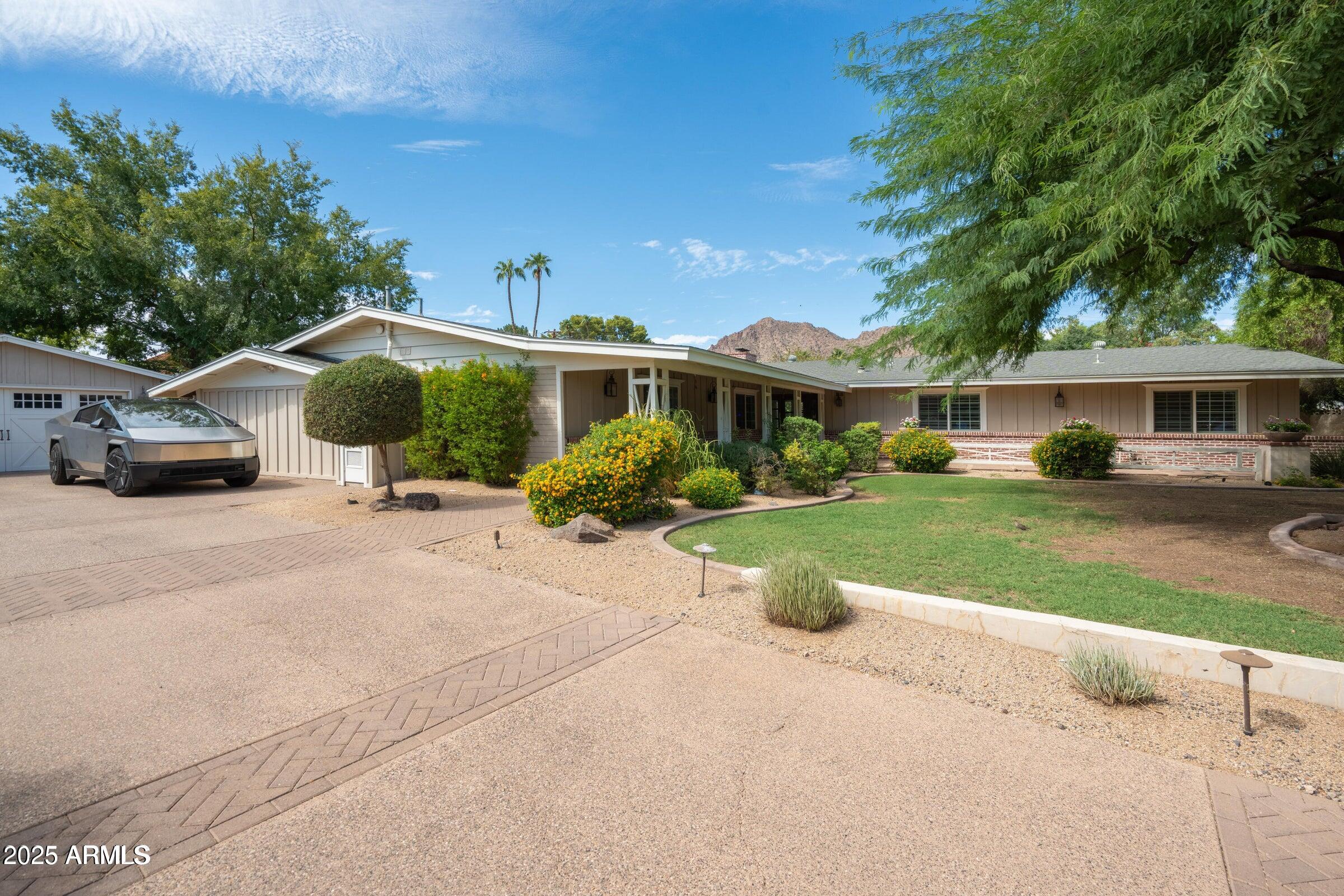 One of the best lots available in Arcadia Proper—nearly 2/3 of an acre on a quiet street with stunning Camelback Mountain views. The lot is flat, highly buildable, and in a prime Arcadia location. The existing home is occupied and very livable, offering the option to renovate, use as a rental ,or live in while you finalize plans and permits.