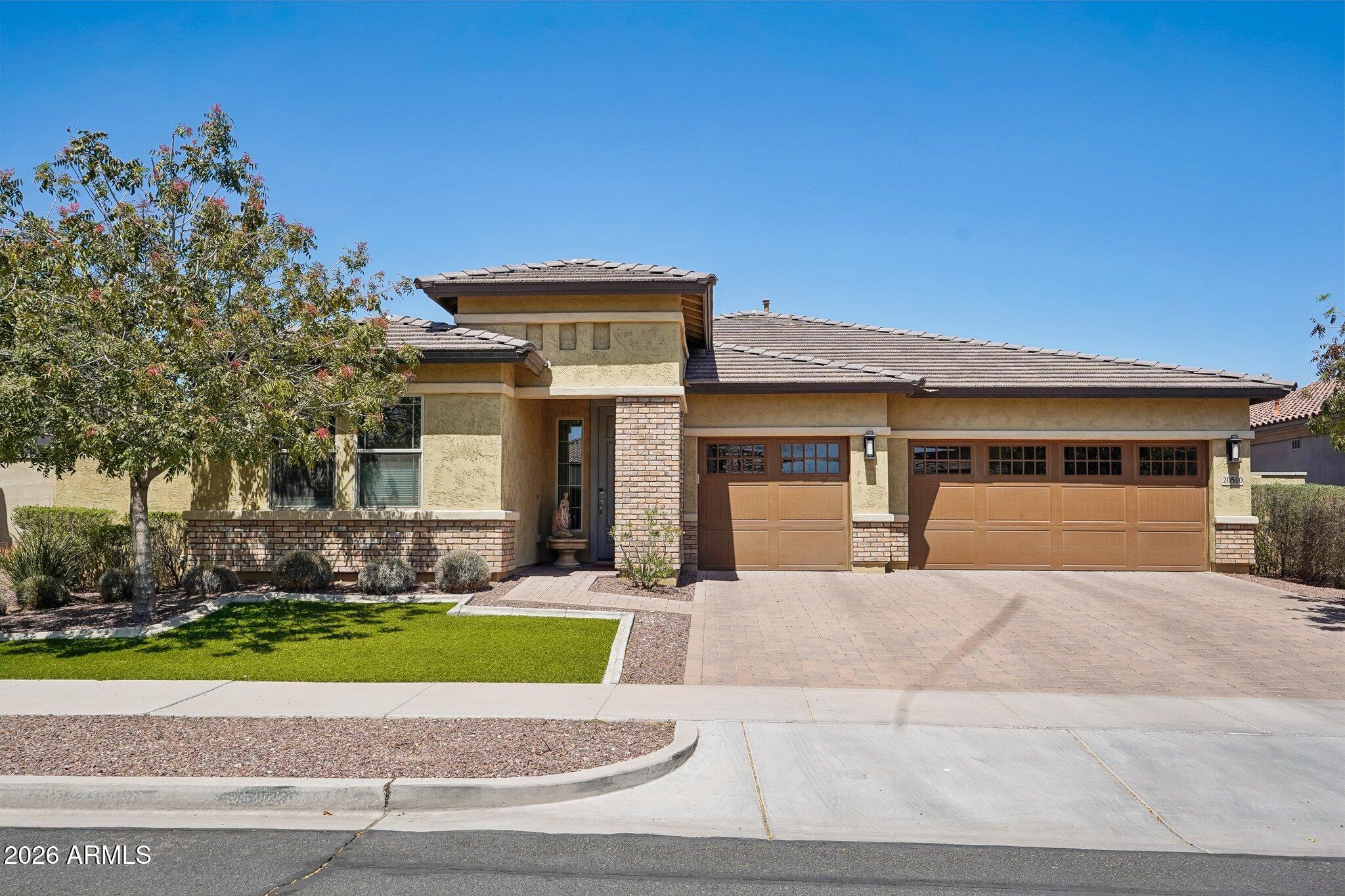 Located in the highly desirable Verrado community, enjoy tree-lined streets, parks, golf, dining, tennis, and a true small-town feel. This spacious and inviting Kennedy floor plan, offers 4 large bedrooms plus a versatile den/office. The central family room creates a natural gathering space, with bedrooms split from the master for added privacy. An elegant dining area opens to a generous kitchen and great room, ideal for everyday living and entertaining. Features include upgraded Cherry Bordeaux cabinets, stainless steel appliances, granite countertops, a glass and marble mosaic backsplash, upgraded tile and wood flooring, an insulated garage, and RO system. Low maintenance front and back yard with a firepit for those cozy nights and year round events for residents