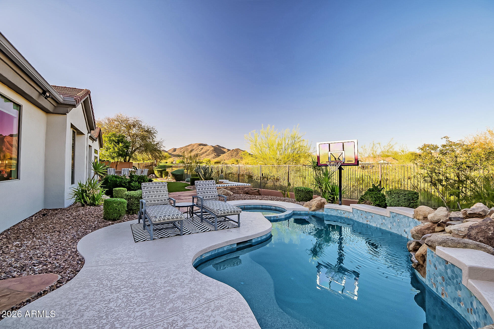 Seize the chance to own a Smart home with a captivating mountain and golf course view. Modern Turnkey residence features advanced technology, seamless automation, and stylish design, providing luxurious living ideal for those seeking comfort and sophistication. 

Imagine a lifestyle where your backyard is a personal oasis. Lounge in sparkling pool, unwind in a soothing spa, and gather around a cozy fire pit. Perfect your putt on the green & host BBQs at the island.  Lush landscaping and majestic views offer relaxation and endless entertainment.

The modern gourmet kitchen is equipped with a full-size wine fridge, island, breakfast bars, coffee bar, quartz counters, enormous walk-in pantry, and Ruvati workstation sink. 

Spacious en-suites are ideal for guests or multi generational families providing privacy & comfort. 

Home office with custom cabinetry. Stunning lighting throughout, gorgeous fireplace, new tile showers, quartz counters, Kohler faucets. Every detail has been carefully thought out. Move in ready for your enjoyment.

Experience Resort Style Living at its FINEST!

Anthem Country Club is a private, gated country club community offering 36 holes of Championship Golf, Tennis and Pickle Ball courts, 2 Fitness Clubs, 2 pools and 2 restaurants and clubhouses.