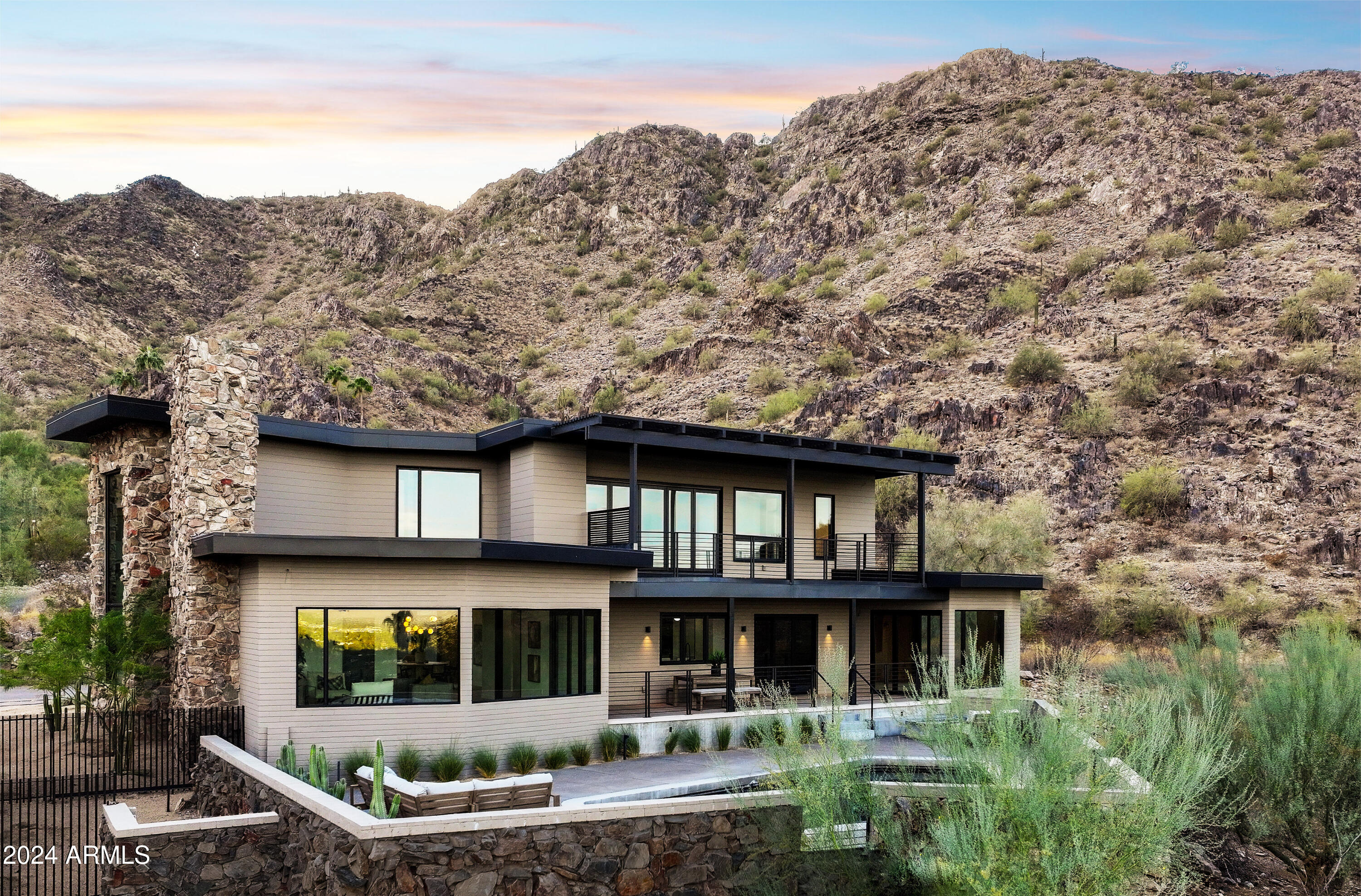Welcome to Arizona's most prestigious real estate enclave nestled in Paradise Valley—. This four bedroom, three and a half bathroom, masterpiece boasts a stunning 270-degree panorama over Scottsdale, the McDowell Mountains, and pristine high desert landscapes. Designed with a striking mid-century modern aesthetic that seamlessly blends with sophisticated contemporary elegance, this residence is crafted by one of Arizona's premier luxury builders, creating a livable art piece. Every inch is meticulously curated, featuring an expansive view deck, walls of glass, a gourmet chef's kitchen, and an opulent primary suite. Perfect for grand entertaining or intimate gatherings, this residence offers unmatched style and captivating, sweeping views.