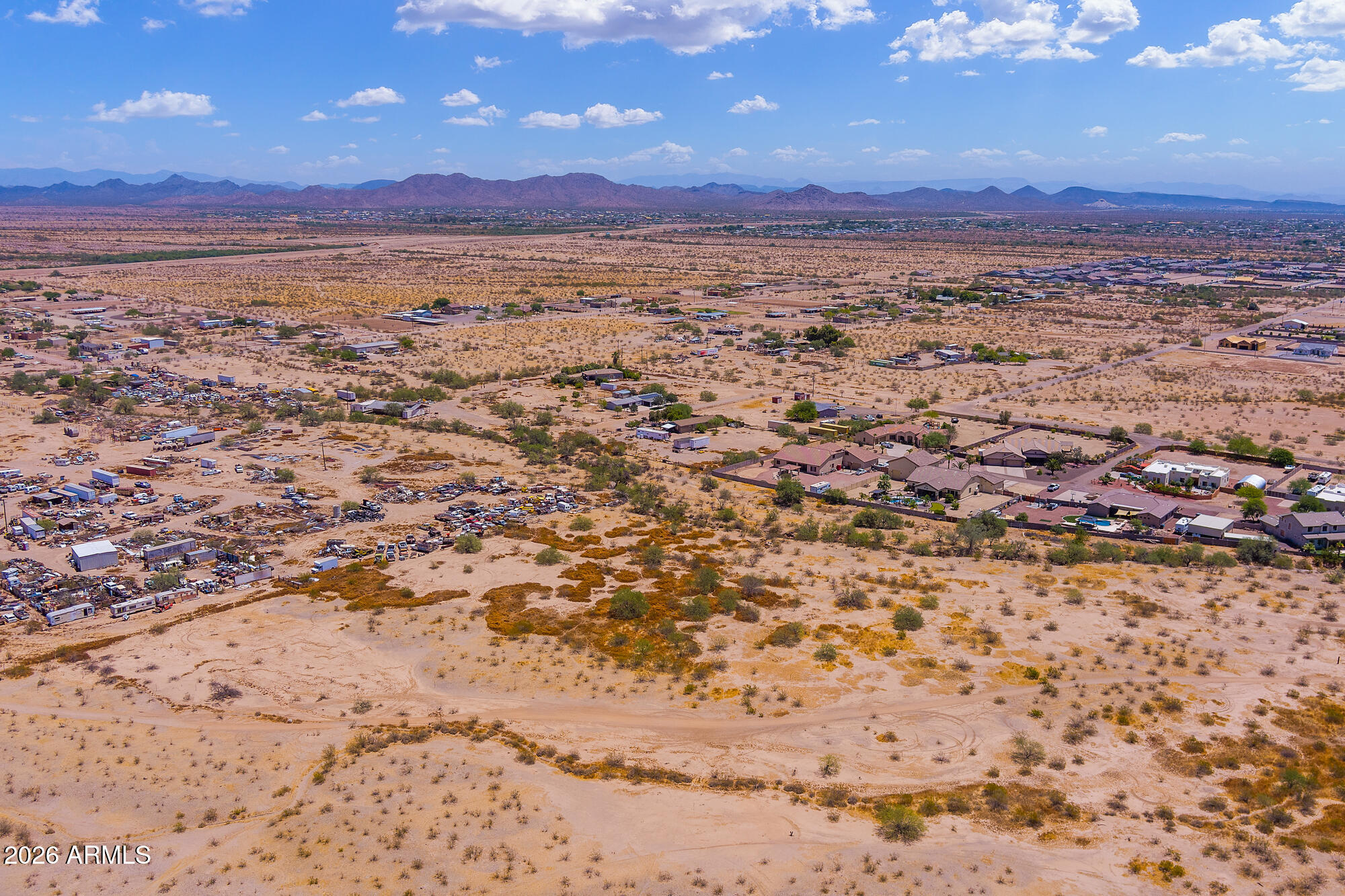 Situated in a premier growth corridor of Surprise, Maricopa County, this 5-acre triangle-shaped parcel zoned R-43 presents an extraordinary canvas for visionary development. The land can be split into one-acre lots, making it an excellent opportunity for a small subdivision, a family compound, a vacation rental complex, or a horse property. Surrounded by luxury homes and newly developed neighborhoods, it offers breathtaking mountain vistas and a level, buildable site with readily available utilities and wells in the area. With no HOA or CC&Rs to hamper your plans, you have the freedom to design precisely what you envision. The property is just 30 miles from Lake Pleasant and is seamlessly connected to major corridors, including Loop 303 and I-10, placing shopping, dining, dining, services, and endless recreation at your doorstep. This is a rare chance to secure acreage in a high-growth zone, surrounded by thriving commerce and unparalleled natural beauty.