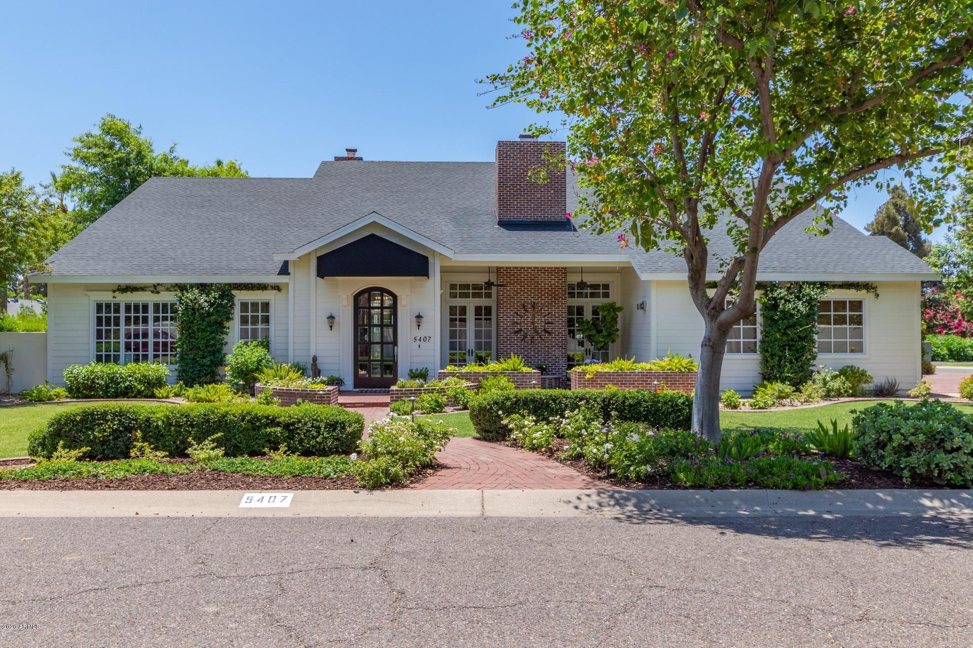 Stunning light & bright Cape Cod style Arcadia home on large, lush lot.  Soaring ceilings, multiple tall French doors, Clerestory windows, spectacular great room w/ exquisite kitchen, 3 fireplaces, wide plank solid wood flooring, beautiful millwork, finest finishes throughout.  5  bedrooms + flex room/office. Stunning master suite.  Set on quiet street w/ beautiful curb appeal,  sparkling pool w/ water feature, outdoor kitchen w/ dining area, fire pit & lovely trees.  Oversized 3 car side entry garage, huge laundry room, so much more (See list of features).  New roof in 2020.  3  blocks to Hopi Elementary school. This home has been featured in many commercials due to its warmth & timeless classic charm.