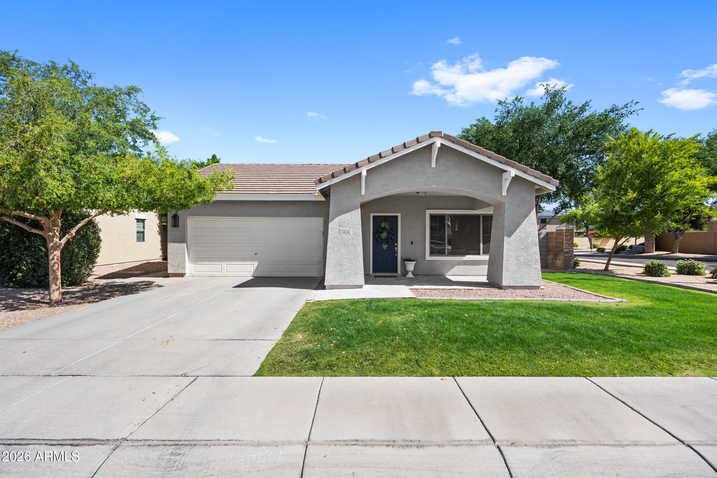 Welcome to this beautifully maintained 4-bedroom, 2-bathroom home offering approximately 1,932 square feet of comfortable living space in the highly desirable Seville community of South Gilbert.

From the moment you arrive, the curb appeal leaves a lasting impression, featuring lush green grass in both the front and backyard, along with thoughtfully placed pavers that enhance the home's inviting exterior. Inside, you'll find a neutral color palette, wood-look flooring, and porcelain tile in all the right places, creating a warm and cohesive feel throughout. The bedrooms are complete with brand-new carpet, while ceiling fans and window blinds add functionality throughout.

The well-designed layout offers separate living and dining spaces, perfect for both everyday living and entertainin The eat-in kitchen is welcoming and practical, featuring stainless steel appliances and a charming farmhouse-inspired color scheme that adds character and style.

The backyard is designed for both relaxation and entertaining, seamlessly extending from the dining area to create a true indoor/outdoor living experience. With ample space for dining tables, outdoor games, and BBQ gatherings, it's the perfect setting to host or unwind. Lush real grass wraps around the home, offering plenty of room for play, pets, or simply enjoying the open space.

Additional highlights include a 2-car garage and a premium corner lot with only one neighboring home, offering added privacy along with ideal north/south exposure. All of this is conveniently located within the Chandler Unified School District and close to everything South Gilbert has to offer, including the brand-new Target currently under construction!