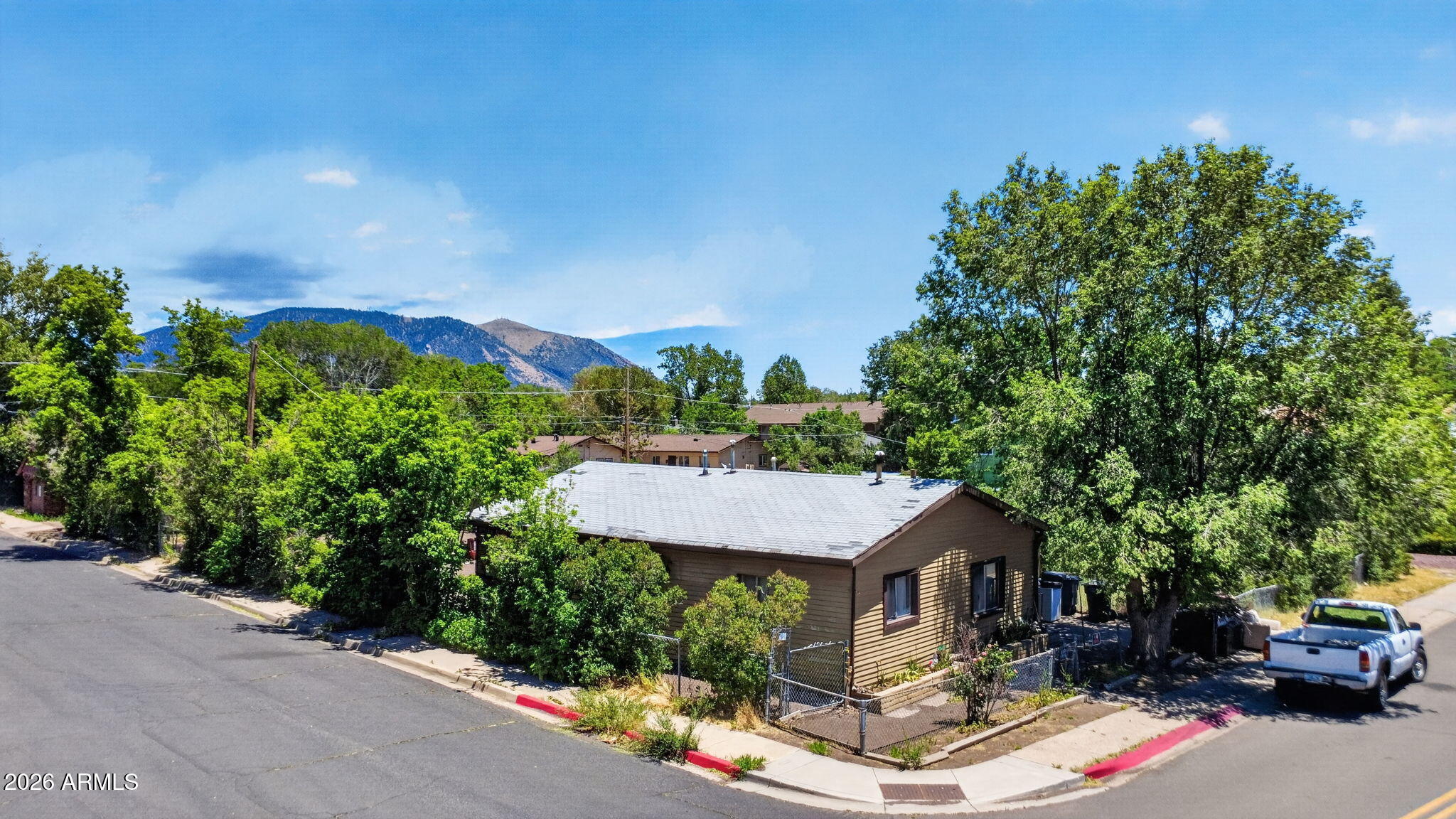 Opportunity is knocking! This fixer-upper in the heart beautiful Flagstaff is ready for an investor or lots of TLC to make it your own. Located on a large, fenced corner lot, this one story home is just moments from Downtown Flagstaff and NAU and there is no HOA! There is a sun room not included in square footage and a garage! Whether you refresh the existing home, add an ADU or start anew, there is so much potential here! This is an as-is, cash only sale. Price reflects condition.
