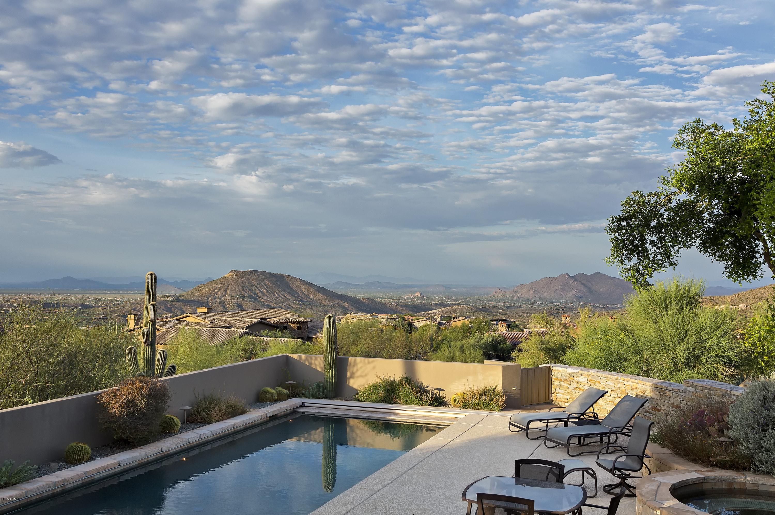 RARE - UNIQUE - UNBELIEVABLE VIEWS - Incredible Dance of Light, Rich Saguaro Surroundings, Salcito-Built Quality, Est Est Luxury Design. Perched at the top of Saguaro Forest in Desert Mountain this Taliesin styled contemporary home flows with light from dozens of exceptionally placed windows. Extensive stone patios lead to an extremely private pool & spa. Multi-faceted living areas insure comfort, whether entertaining 100 guest or escaping to enjoy the serenity of the location. Stone, glass, wood, and light enhance every living space.  Three bedrooms with en-suite baths plus separate entry guest suite with living room. Exceptional views from all patios; Lanai Room off kitchen has telescoping screen doors opening to Sunset Viewing Deck, with Fireplace, TV, & BBQ Grill. Media & Office for 2