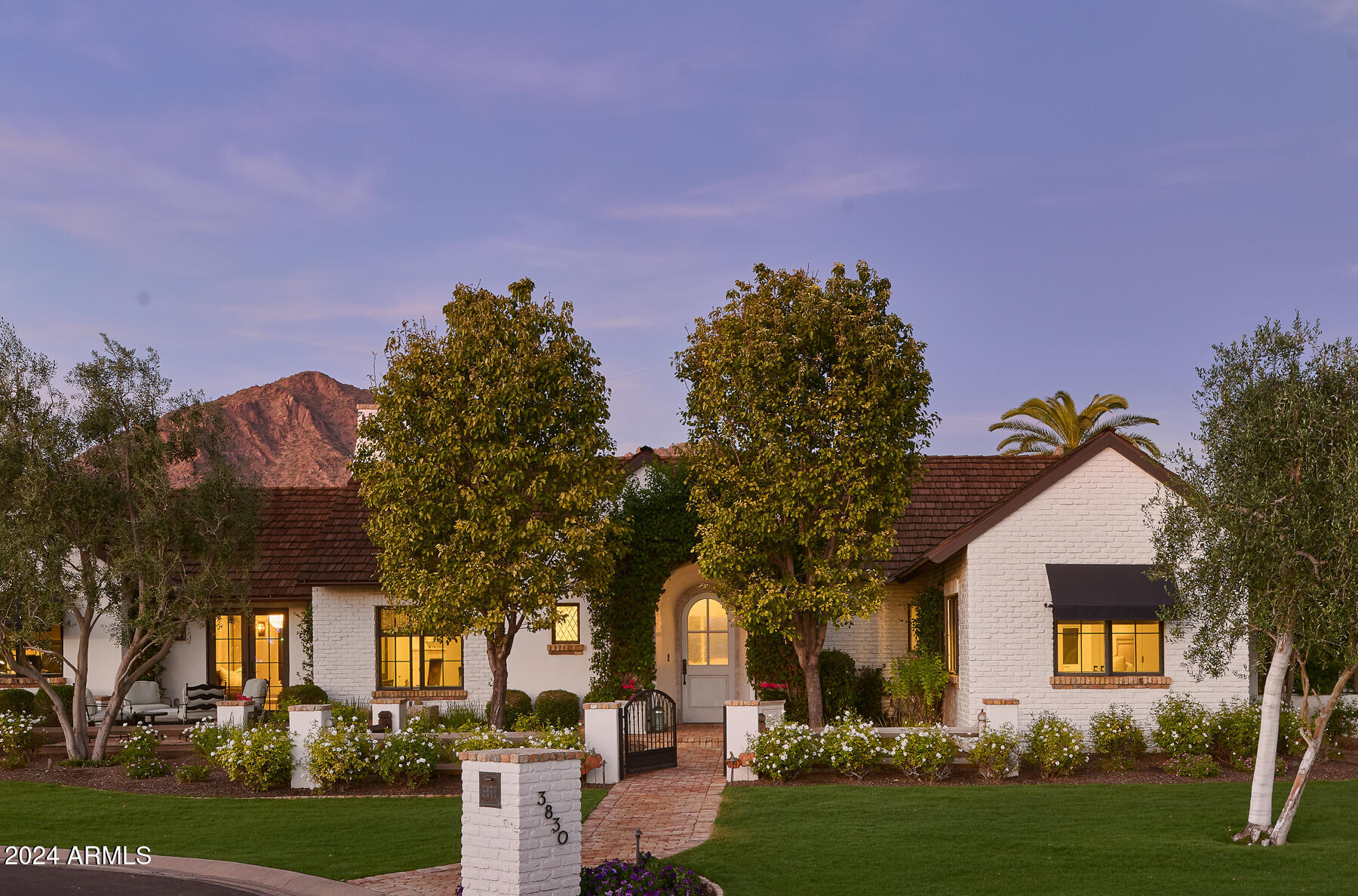 Nestled in the heart of Arcadia, this tastefully designed home exudes elegance and sophistication. With its open spaces and thoughtful layout, it offers the perfect setting for both comfortable living and entertaining. The property boasts stunning views of Camelback Mountain, providing a picturesque backdrop for everyday enjoyment.
Upon entering, you'll be greeted by the seamless blend of modern and classic elements that define this home. The interior features four bedrooms, 3.5 bathrooms, a luxurious master suite, and private den. The wood flooring throughout adds warmth and charm, complementing the custom tiles that adorn the bathrooms and kitchen. The kitchen itself is a culinary enthusiast's dream, featuring top-of-the-line appliances and a spacious island for gathering with loved ones. Wooden beams grace the ceilings, adding character and a sense of architectural distinction, while the neutral palette enhances the home's chic aesthetic. Additionally, a wine cellar is the perfect place to store and showcase your collection.
Stepping outside the entertaining areas are thoughtfully designed, featuring a pool, spa, putting green and unobstructed Camelback mountain views. This charming property offers a seamless fusion of modern comfort and classic elegance. With its open living spaces, stunning mountain views, and luxurious amenities, it provides a truly exceptional living experience in the heart of Arcadia.