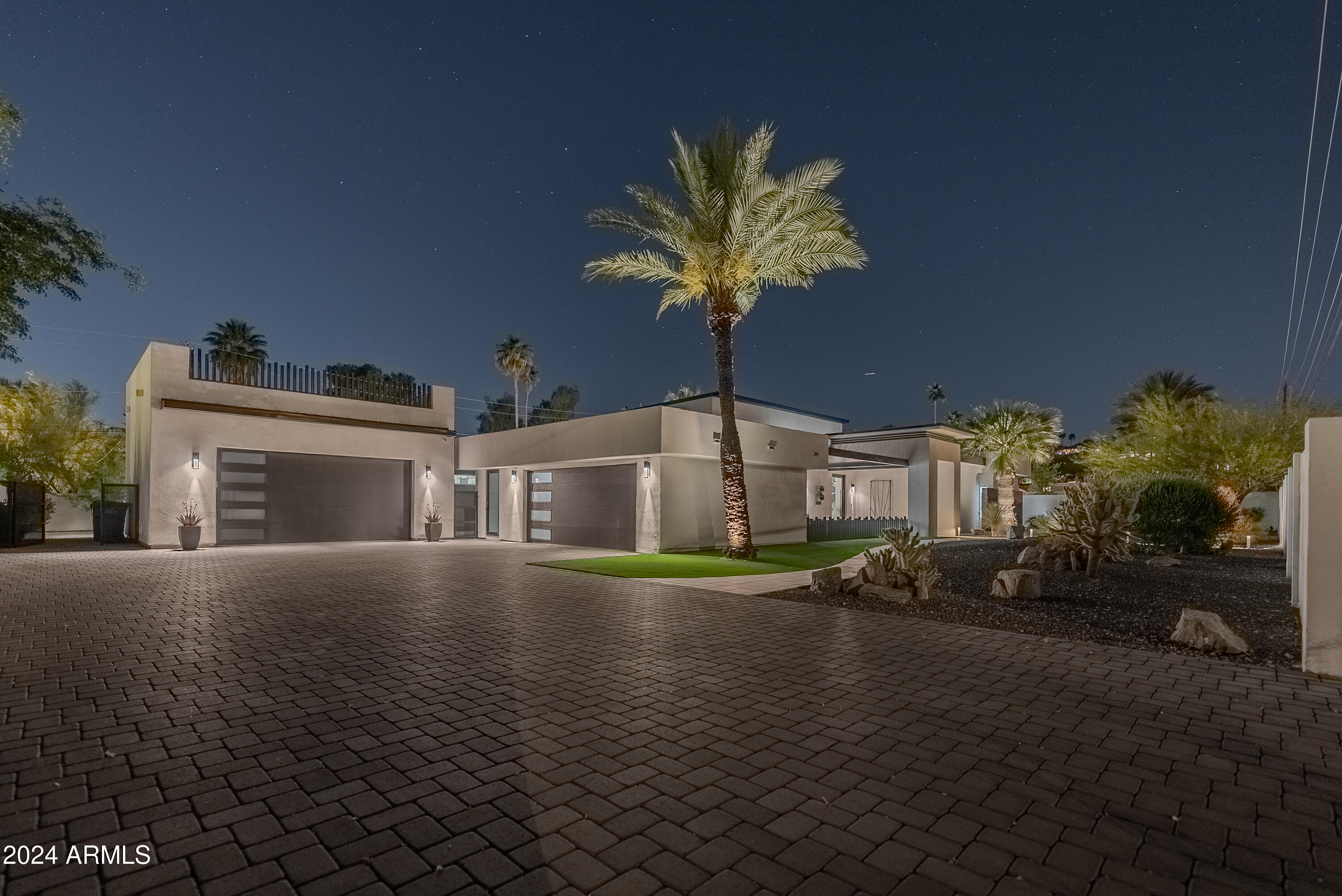 Welcome to this stunning, fully renovated modern home that masterfully blends luxury with functionality. Boasting 4 spacious bedrooms, 4.5 baths, and a dedicated office, this home offers a perfect balance of comfort and style. The oversized master suite is a true retreat, featuring its own sitting area with views of the pool and backyard oasis. Step into the expansive great room, where 20-foot wide, 10-foot tall sliding glass doors open to breathtaking mountain views. A 16-foot tall fireplace anchors the room, creating an inviting focal point, while a sleek bar and wine wall add an extra touch of elegance. The design and finishes throughout are top-tier, showcasing high-end upgrades and modern details at every turn. The home is ideally situated just moments from Paradise Valley, Arcadia and Biltmore, offering the best of both privacy and convenience. The beautifully landscaped backyard is an entertainer's dream, complete with a sparkling pool, covered patio, built-in BBQ, and a putting green  perfect for relaxing or hosting gatherings.
This extraordinary home offers the perfect combination of luxurious living, remarkable design, and an unbeatable location. Don't miss your chance to make it yours!
