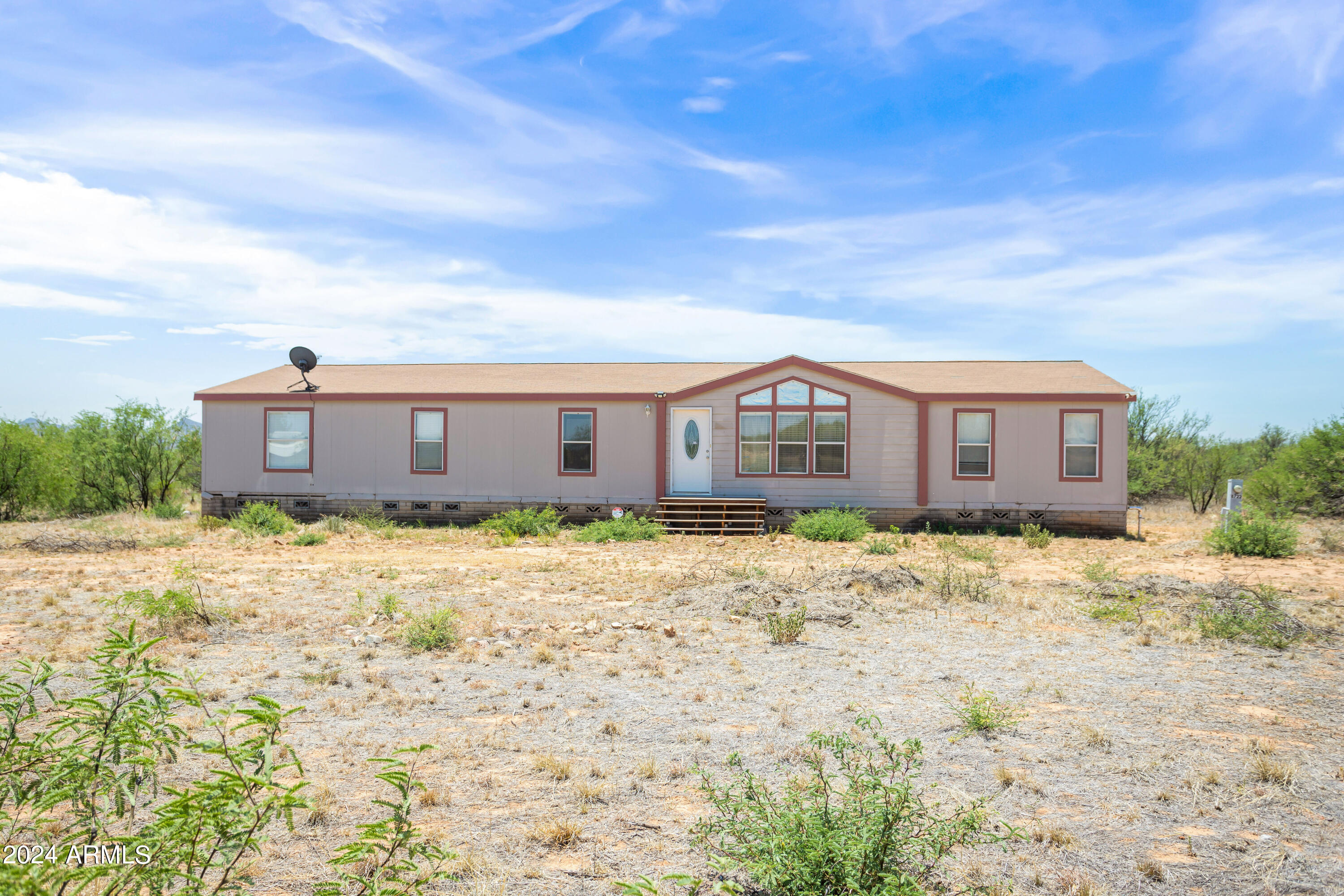 SOLD AS IS - Charming 4 bedroom, 2 bathroom, Fixer-Upper Manufactured home on 4 acres with stunning views.  Embrace the opportunity to transform this house into your home! Perfect for investors or anyone looking to create their dream house! This property has immense potential!