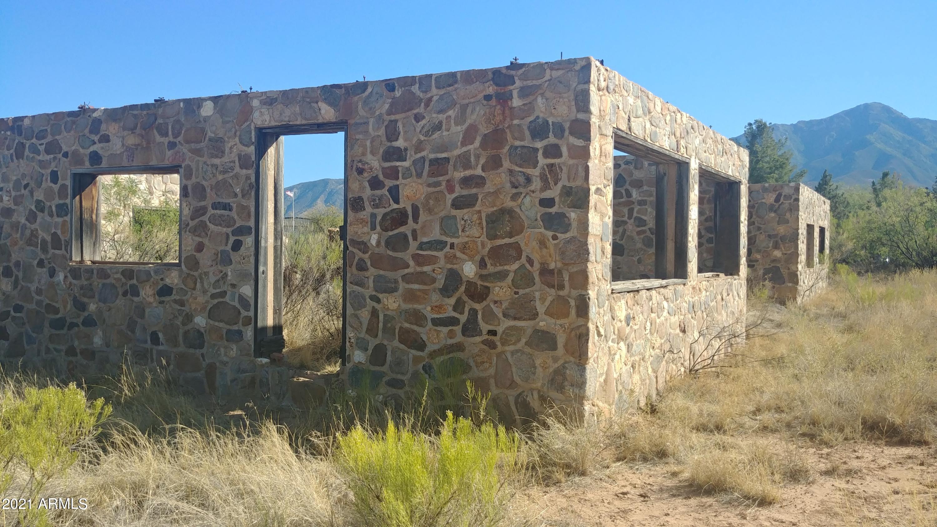 Almost an acre parcel (0.965) of HORSE PROPERTY on paved road. Corner of Calle De La Mango & Calle De La Manzana.  Garden Valley subdivision in Hereford. Approximately 1,900 square foot unfinished Rock House. Unlimited potential! Mountain Views.