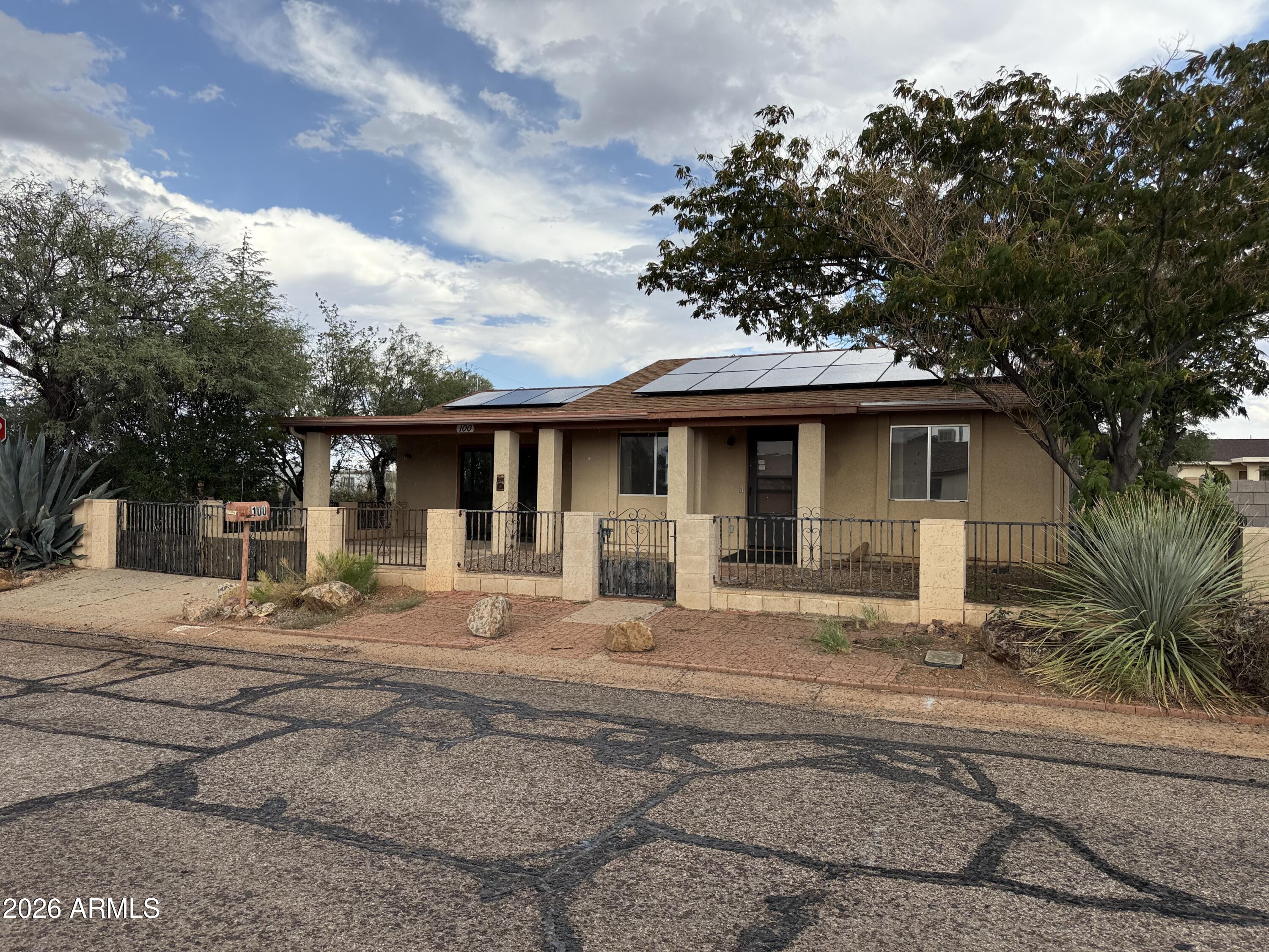 This is a wonderful price for a home with solar! The garage was converted to a large family room and there is a 3/4 bath that was added off of it. The home also has a very nice shed and an outdoor BBQ/fireplace area off of the covered rear patio. The kitchen has oak cabinetry and a breakfast room. The main bath has a walk in tub and is handicap accessible. The property is completely fenced as well.