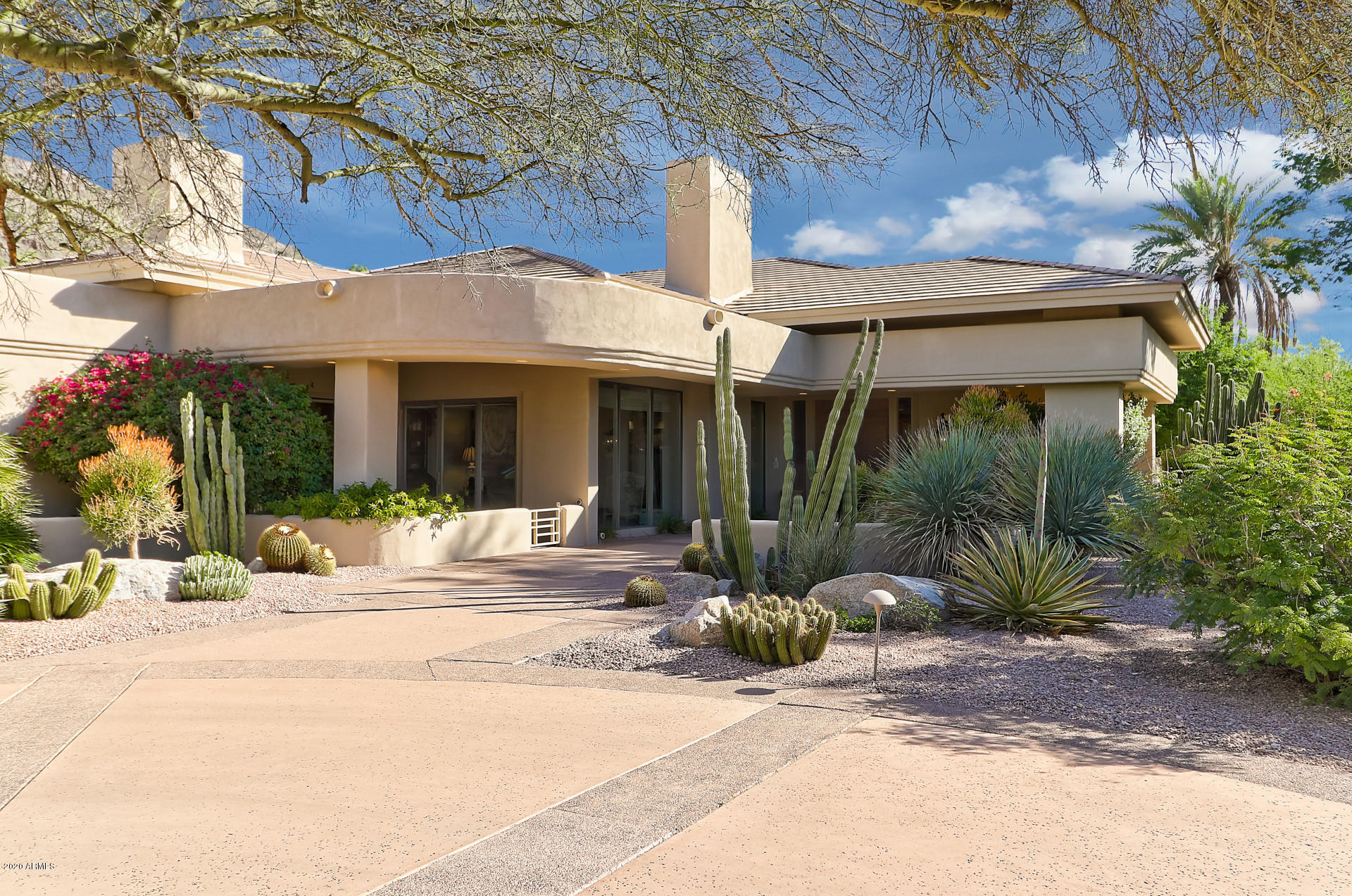 Located in the most sought after area of Paradise Valley, at the end of a small cul-de-sac, this exceptional home combines total privacy with breathtaking views of both Camelback and Mummy Mountains. The home boasts 4 bedrooms, 4 gas fireplaces, 6 baths and custom woodwork and stonework throughout. Custom wet bar with refrigerator, ice maker and 146 bottle Subzero wine storage. Oversized rooms with 14 foot ceilings. Herringbone white oak flooring in main rooms, travertine tile in all baths. Steam shower in master bath. The backyard will be your private retreat, complete with stunning mountain views, gas fire pit, and heated saltwater pool and spa surrounded by a custom travertine deck. Large ramada with DCS gas grill for casual outdoor dining. The perfect blend of privacy and convenience.