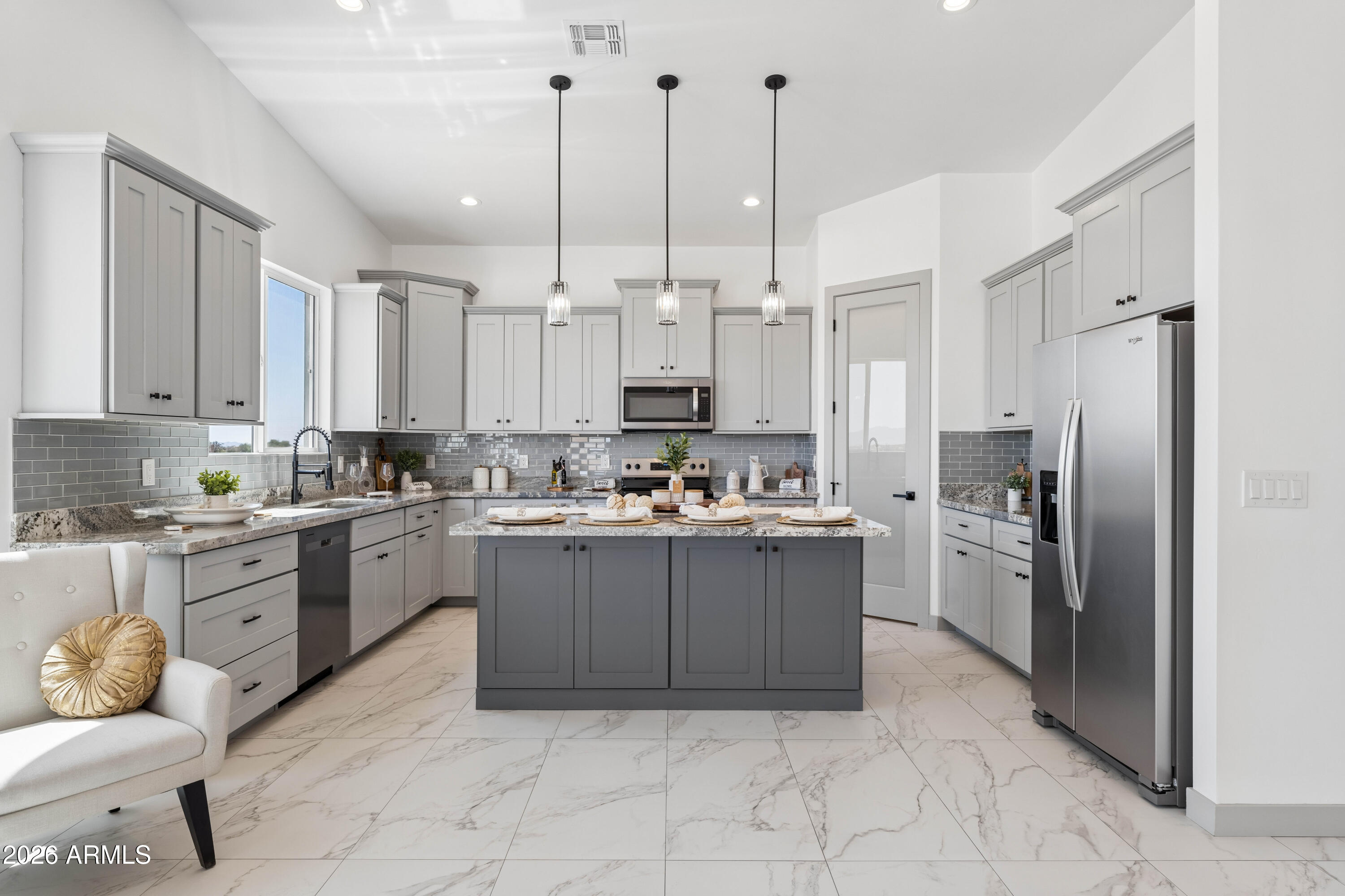 Experience custom desert living in this beautifully designed 4-bedroom, 3.5-bath home in Tonopah featuring modern architecture, soaring ceilings, oversized doors, and an open-concept layout filled with natural light. Offering approximately 3,224 SQFT under roof (2,297 livable), this new build showcases Alpino White 20x40 porcelain tile flooring, clean modern finishes, and an airy, expansive feel throughout.
The spacious kitchen features custom-style cabinetry, a large island, and appliances backed by a 2-year warranty. A split floor plan provides privacy and comfort, while the primary suite offers a beautifully designed bathroom and generous walk-in closet.
Situated on a spacious lot with room for RVs, toys, animals, or future additions, this property combines modern living with flexibility and open desert surroundings. Shared well servicing only 2 homes adds efficiency and long-term value. A second similar home is also available next door, creating a rare opportunity for multi-generational living, investment, or extended family ownership.