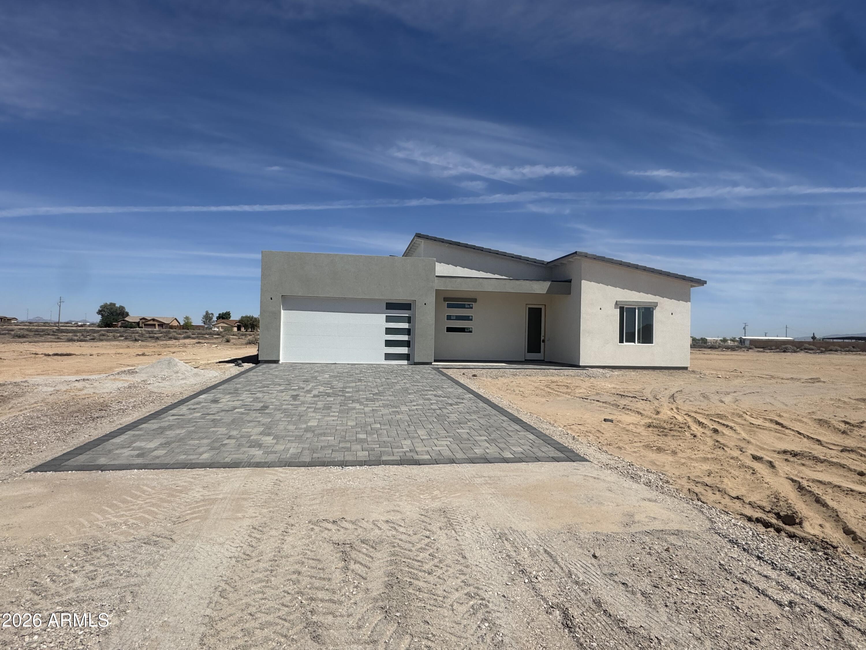 Beautiful contemporary home situated on a spacious 1.25 acre lot in Tonopah, offering the prefect blend of modern design and peaceful desert living with NO HOA.  This 4 bedroom 2 bath home features an open concept, sleek finishes and vaulted ceilings.  The stylish kitchen shows modern cabinetry, beautiful quartz counter tops and stainless steel appliances.  The split floor plan adds additional privacy,  a well appointed master suite with gorgeous walk in tiled shower and walk in closet.  With over an acre to work with,  the possibilities are endless to create your own oasis.  Located minutes from grocery store, gas station, schools and I-10.   Completion is projected to be May 2026.