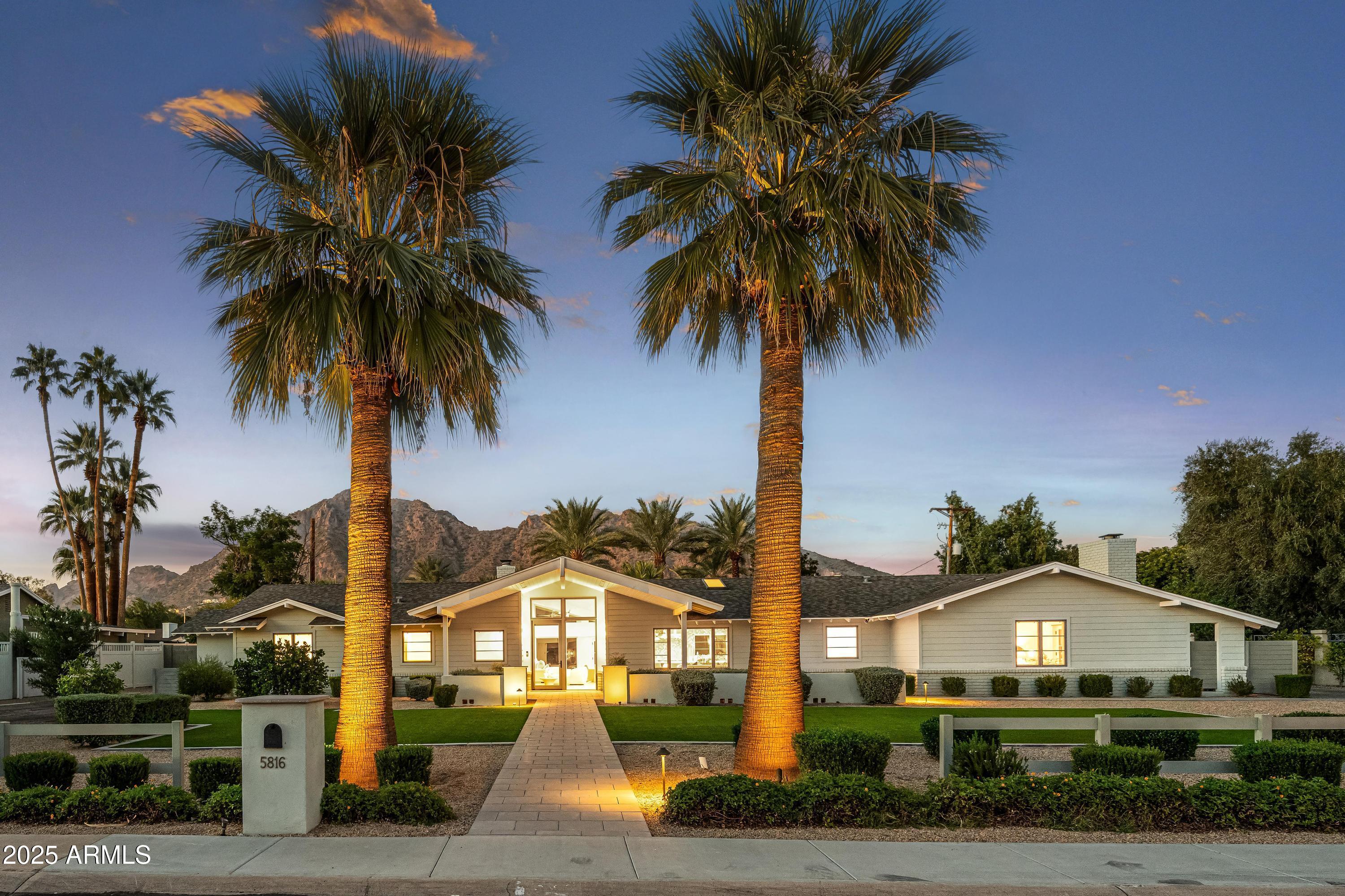 Welcome to the quintessential Arcadia home, where Mid-Century Modern design meets modern luxury. Completely remodeled with meticulous detail, this single-level home sits on a south-facing cul-de-sac lot with unobstructed Camelback Mountain views. Inside, vaulted ceilings and dramatic windows flood the home with natural light. The kitchen features custom cabinetry, premium appliances, and designer finishes.  A thoughtful split floor plan provides privacy and flow with 4 bedrooms and 4 bathrooms. Indoor living connects  seamlessly to resort-style yards, with sparkling pool, spa, and multiple entertaining areas.  Whether hosting gatherings or enjoying a quiet evenings with Camelback as your background, this home offers the ultimate Arizona lifestyle- rare Arcadia opportunity!
