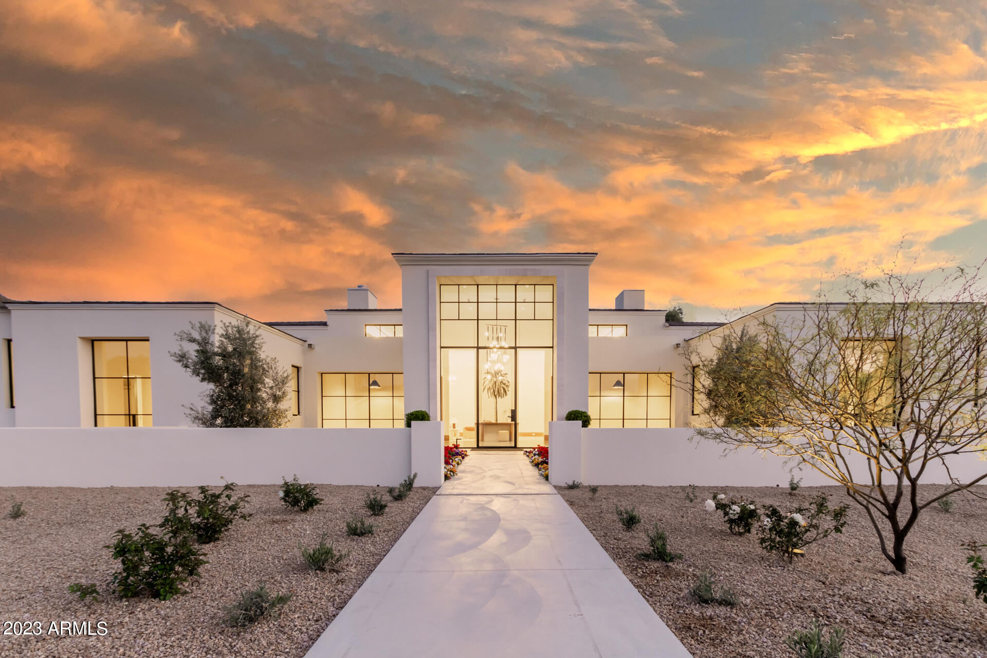 Welcome to Desert Park, a brand-new move in ready estate with views of Camelback and Mummy Mountain, just north of the Paradise Valley Country Club. Designed by Candelaria, all-steel construction by Arcadia Custom Builders, interiors by Katie Bowe Designs, landscaping by Berghoff.
The main house features 5 bedrooms with ensuite bathrooms, two powder rooms, and an office. The South facing backyard has a diving pool with spa, covered patio space, gardens, a second floor deck and room for a sport court. The two-kitchen design stuns with Taj Majal countertops and sleek oak cabinetry. Fully equipped with a spacious pantry and walk-in cooler. Show stopper laundry room with island workspace, double stacking washer/dryers, built-in desk and storage lockers. Detached Casita is a flex space with laundry and kitchenette. Private gated entry with two separate garages, a three bay garage with a dog wash and a temperature-controlled two bay. Both ceiling heights allow for car lifts.