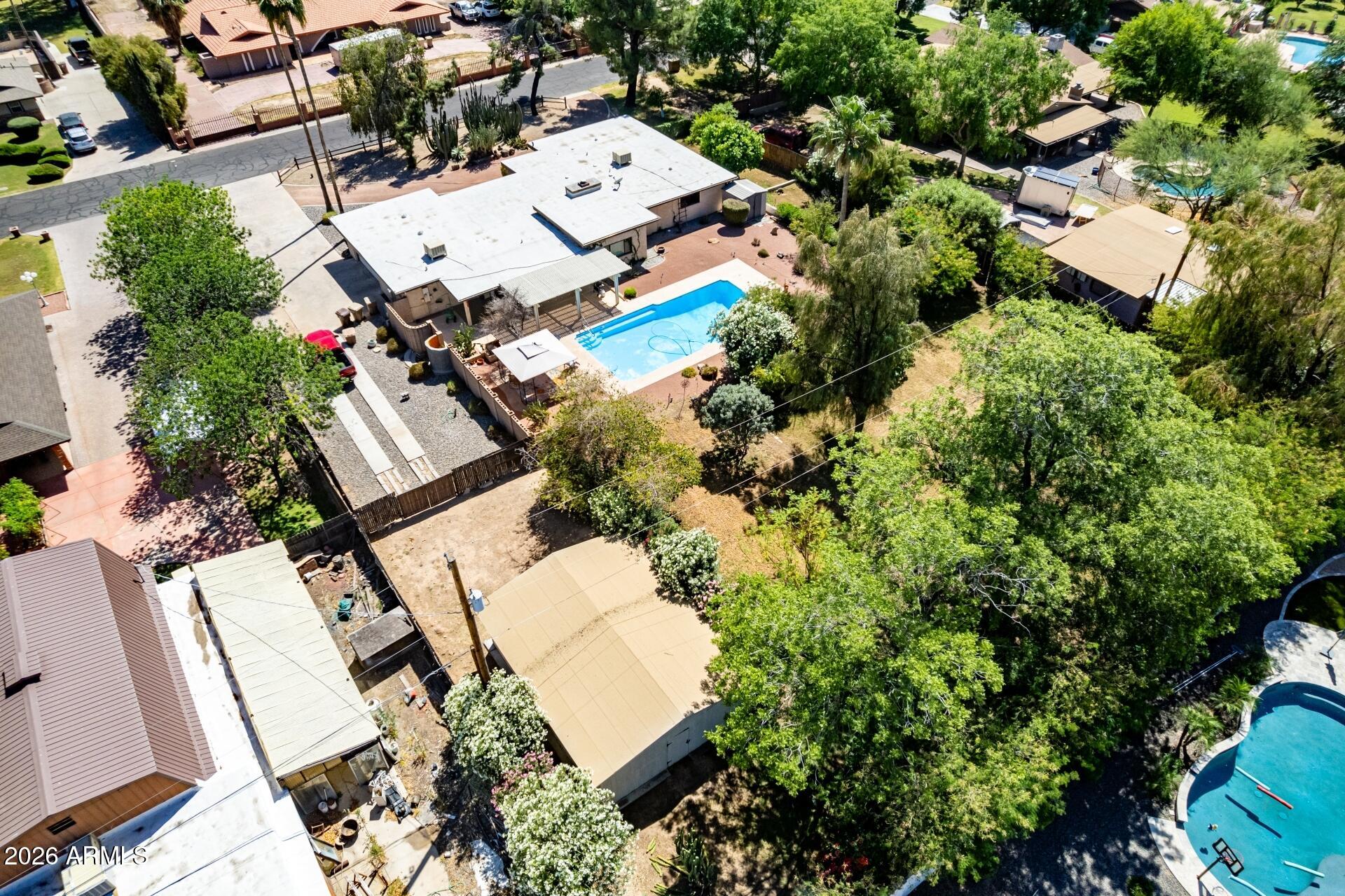 Sitting on 35,000+ sqft lot in Thunderbird Acres with no HOA, This solid block constructed 4 bed/2.5 bath, 2,815 sqft, single-level, horse property features a great floor plan and is ready for your fresh, new ideas and personal touch! The HUGE irrigated backyard features lots of privacy along with a covered patio, pool, stand-alone barn, and mature landscaping, including well-producing citrus trees. This home is a great opportunity for a homeowner or investor, and the large lot with no HOA offers endless possibilities!