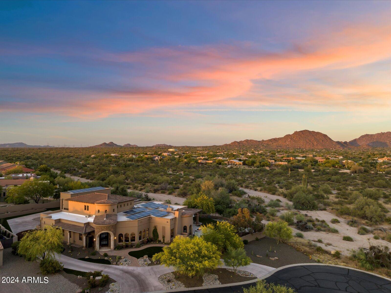 Step into luxury at this meticulously renovated gated estate, nestled beside Pinnacle Peak Mountains. No detail spared in its .84 acres backing to NOAS (feels like 10+ acres) of elegance, featuring fine cantera stone accents, fireplaces, and illuminated onyx countertops. Indulge in a chef's kitchen with top-of-the-line appliances and a cool 340-bottle wine cellar wall. No Steps retreat to its serene primary suite with spa-like bathroom. Outside, a resort-style backyard beckons, with space for RV parking or a 6-car garage (plus room to add 4 lifts) and mezzanine. Room for a basketball, baseball batting cage or pickleball court. Experience its unparalleled grandeur in every detail of this exceptional property. See Motion Video!