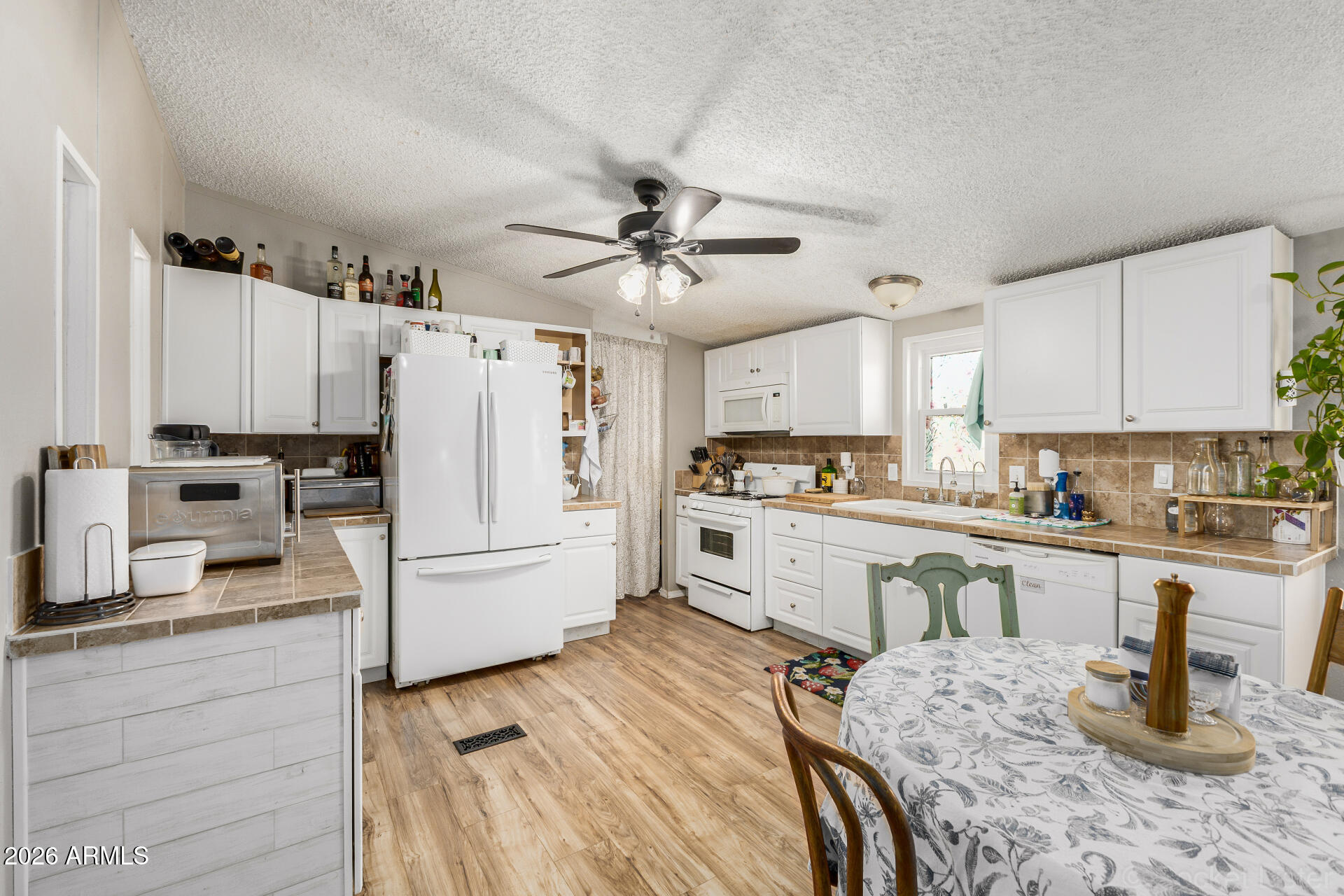 Highly Motivated Seller! Amazing opportunity to live in beautiful Buffalo Ridge! Ideally located near restaurants, schools & parks, this home sits at the end of the street with a block wall for added privacy & XL 10x8 storage shed. The property features a 3-car carport & a cozy covered porch. Inside, enjoy vaulted ceilings, laminate flooring, neutral tones & a bright living area flowing into the dining space. The kitchen offers ample storage, tile countertops, and matching appliances. Major upgrades include a whole-house water filtration system which transfers to new owner, energy-efficient double-pane tilt-in windows, and a premium 40-year roof. The primary suite features dual sinks and a walk-in closet. Walk in closets in all bedrooms. Community amenities include a pool, playground, basketball court & dog park