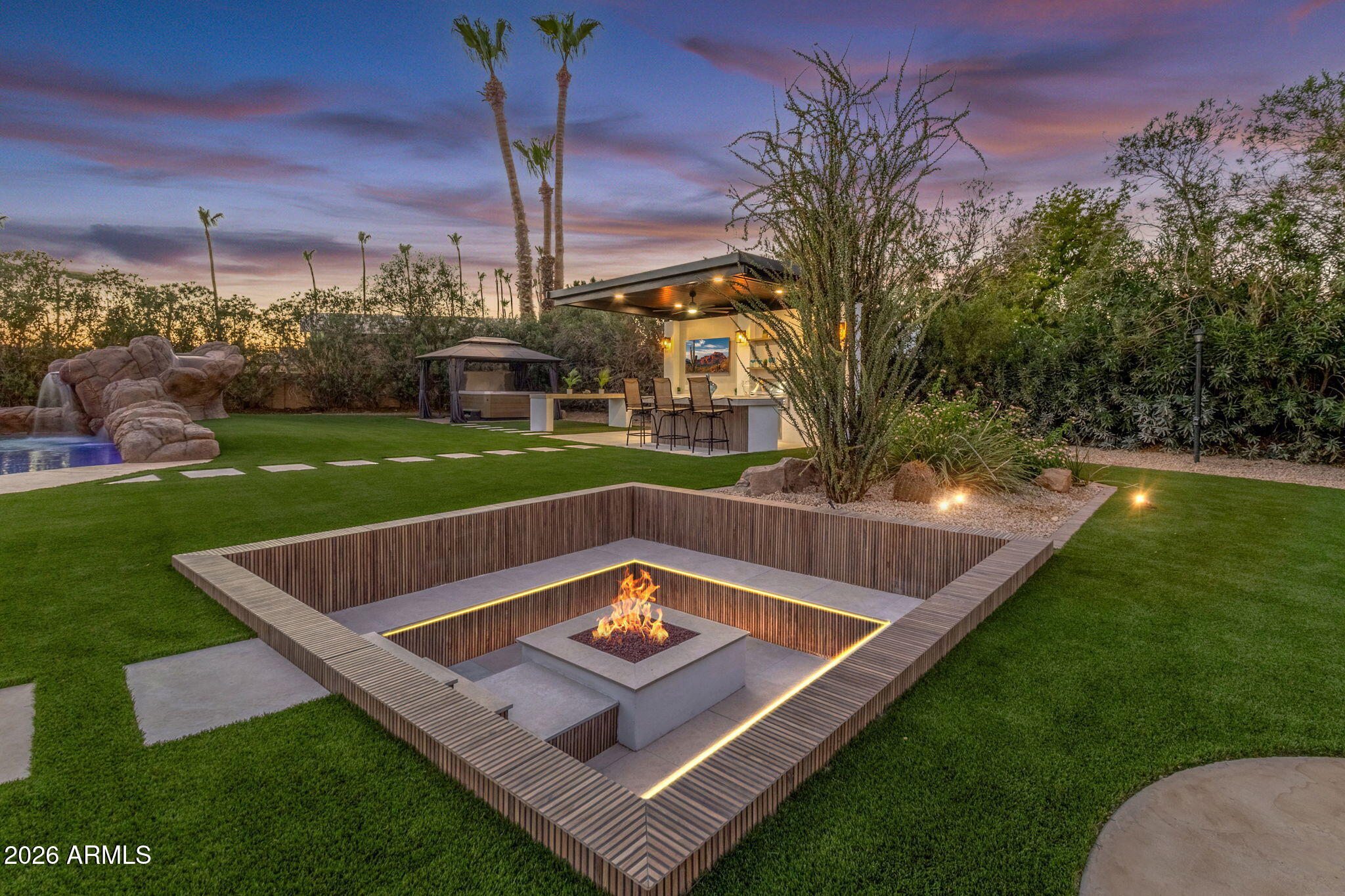 Experience luxury living at its finest in this stunning, fully remodeled estate offering approximately 6,700 square feet of thoughtfully designed living space, including a 5,500-square-foot main residence and a 1,200-square-foot guest house. Featuring 7 spacious bedrooms, 4.5 beautifully appointed bathrooms, and a 5-car garage, this exceptional property combines timeless elegance with modern convenience.

No detail has been overlooked in the top-to-bottom renovation. Enjoy peace of mind with a brand-new roof, new solar system, new HVAC units, and new energy-efficient windows throughout and so much more. The chef's kitchen is a true showpiece, boasting premium finishes, two islands, Cafe appliances, abundant workspace in the butlers pantry, and an ideal layout for entertaining or everyday living. Extensive storage throughout the home ensures everything has its place.

The main house has four bedrooms and three and half baths. The primary bedroom is over 1600 square feet of a spa like feel featuring two large size walk in closets, dual head shower with tub and a room off the bathroom that can be used for a gym, office, or private sitting room just for you! 

Step outside to your own private resort-style oasis, where more than $150,000 was invested in creating an incredible backyard retreat designed for year-round Arizona living. Host unforgettable gatherings relaxing poolside, sitting at the outdoor kitchen watching TV, or enjoying the sunken fire pit. No matter what you do in the backyard you will LOVE it!  

Located on just over an acre with no HOA, this rare property offers the freedom you've been looking for while remaining conveniently close to top-rated schools, shopping, dining, and everyday amenities. This is a one-of-a-kind opportunity to own a completely turnkey luxury estate where every major improvement has already been completed.