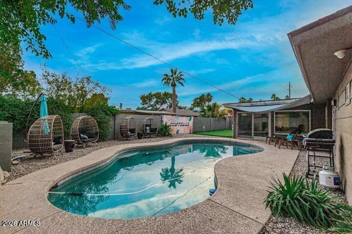 Once in a while does a truly magnificent, fully remodeled modern home such as this gem come available. You will love the kitchen with glass front cabinets, stainless steel appliances, soft close drawers, large island with breakfast bar & wine refrigerator all overlooking the open family room. This home boast a beautiful master suite with spacious master bath with Japanese soaking tub, second master bedroom, bonus room, carport with automatic gate & a backyard with a pool, putting green and relaxing sit down area to enjoy the beautiful Arizona sunsets in the front and back yard. Minutes from Old Town Scottsdale, freeway access, and Sky Harbor Airport! Make this gem your home today!!