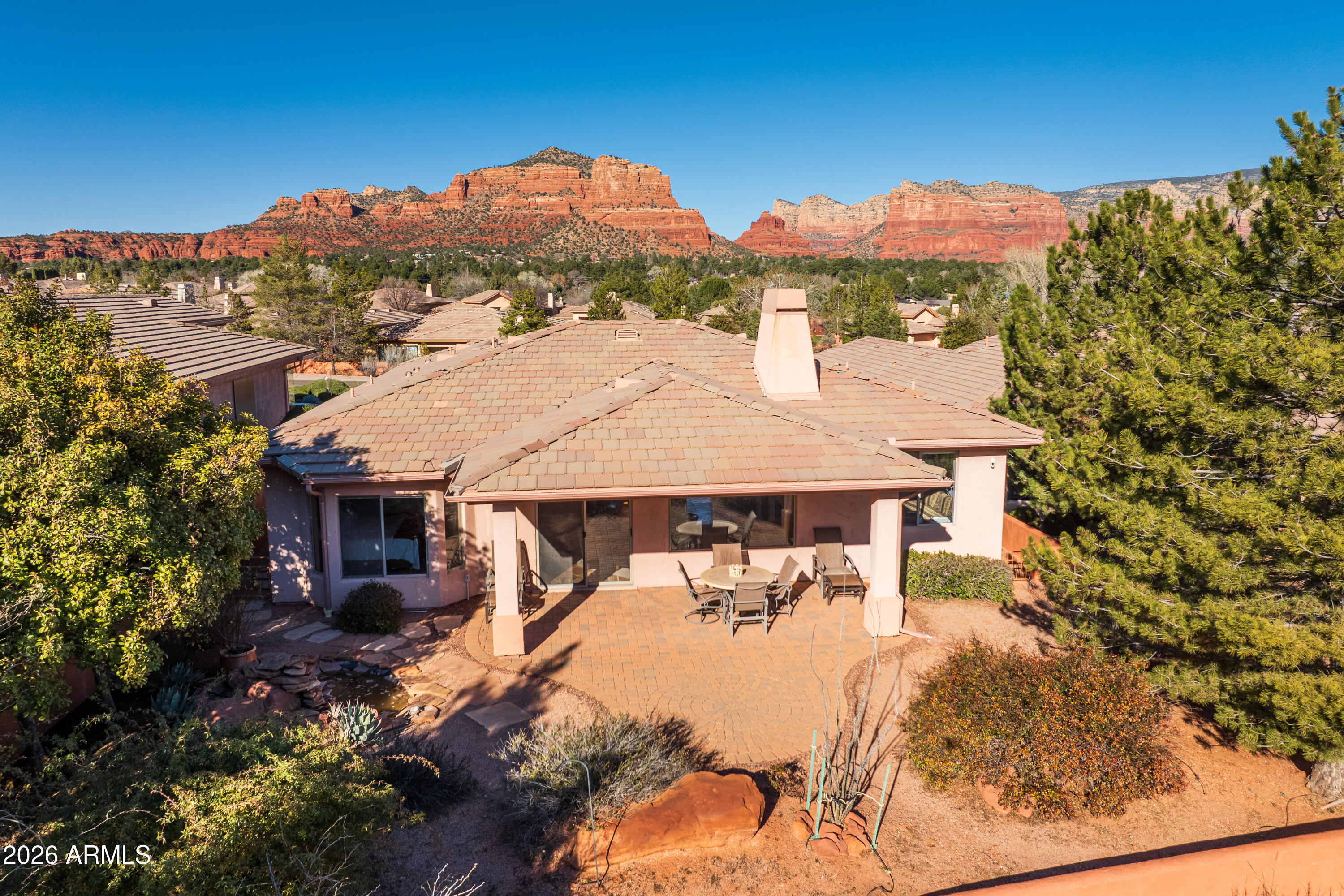 An attractive compact low maintenance single level 3 bedroom 2 bathroom home enjoys the natural beauty of the Red Rocks, including Bell Rock, from the front. To the rear, the covered back patio has views of the desert green landscape of the Mesa. It also runs alongside the fairway of the 5th Hole of the popular Sedona Golf Resort. You can also see the lake that sits in front of the 5th Tee. The elevated ceilings and large windows give the home a warm but open feeling, bringing the outside in. Split floorplan. Main Bedroom with en-suite bathroom and two bedrooms with bathroom in between. This home enjoys two other bedrooms, one of which could easily be utilized as an office, den or work out room. The home is genuinely one level, with no steps or differing levels to negotiate. The wood burning fireplace in the living room has never been used by the current Owners.