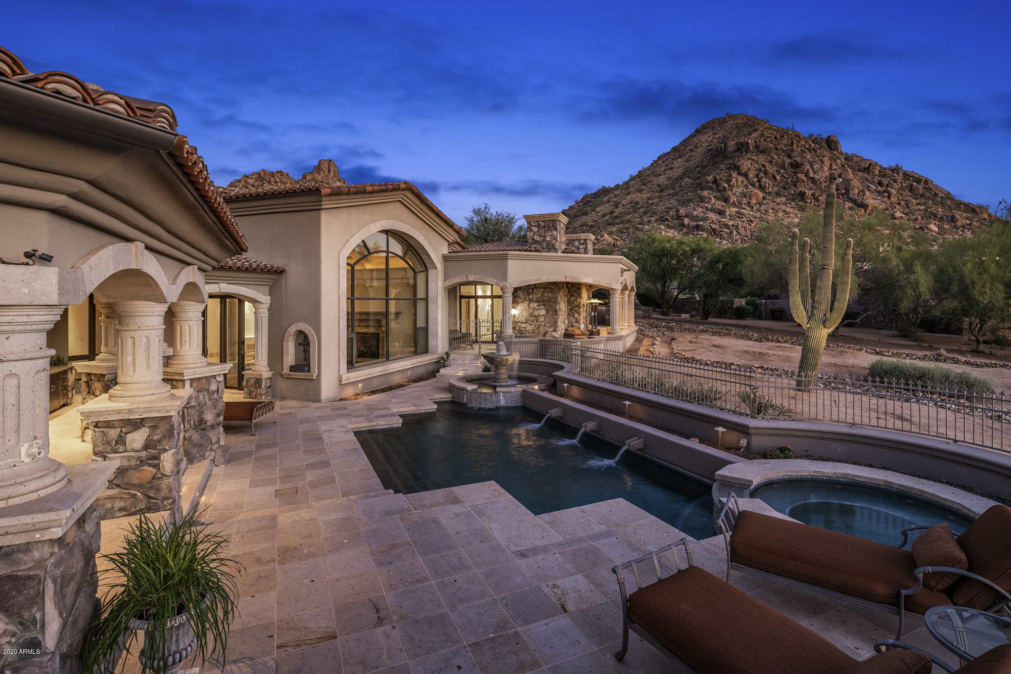 An exquisite estate located on a quiet cul-de-sac overlooking the 5th fairway of Estancia, a private golf club with 24/7 guarded gates. Potential multigenerational living designed for privacy. Premium view lot also offers unparalleled sunsets, moonsets, city lights, & mountain views. Custom built & thoughtfully designed with w/ extensive use of hand crafted wood & natural stones. Abundant storage. Chef's kitchen with large center island & butler's pantry...flowing seamlessly to the main gathering area of the home. Family room with a custom carved/handcrafted bar having spectacular views. Large covered patios w/ heated pool/spa, & an outdoor kitchen, excellent for entertaining. Over 8,000 sq. ft., this meticulously maintained home exudes true pride of ownership.
