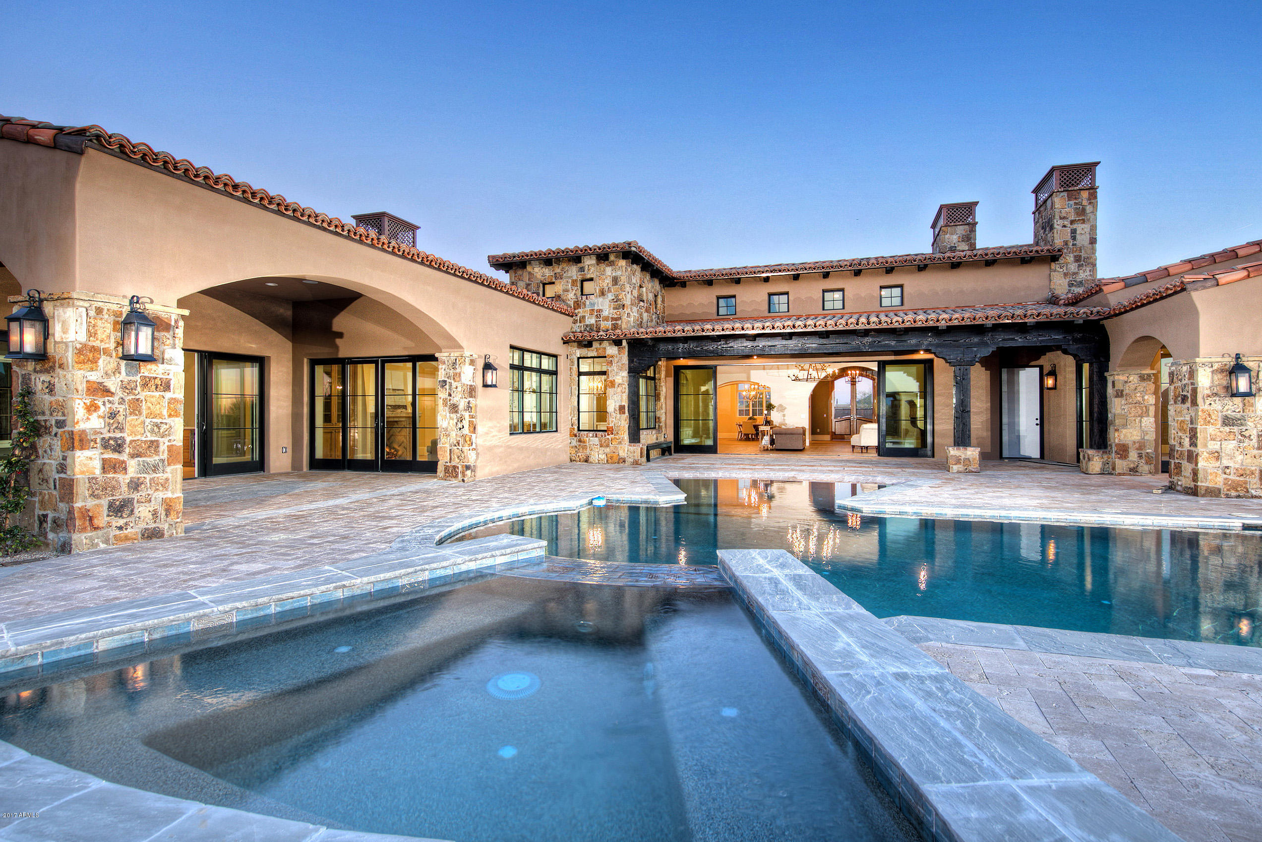 Located in the guard-gated community of Whisper Rock, this stunning residence is thoughtfully positioned on an elevated lot with some of the best views Whisper Rock has to offer. An open concept plan, this home features the latest finishes, all on one level.  Fabulous entertainer’s kitchen with furniture grade cabinetry, butler pantry with large wine refrigerator. 4 guest bedrooms in the main house, each with ensuite and walk-in closets. Master suite has his & her walk-in closets and luxurious bath. Custom office with floor to ceiling woodwork. Reclaimed barn wood beams in the kitchen. Control 4 fully automated lighting and AV control. Smart pool with unique lighting features. Retracting glass doors bring the outdoors in, showcasing the grand pool area & surrounding scenic desert views.