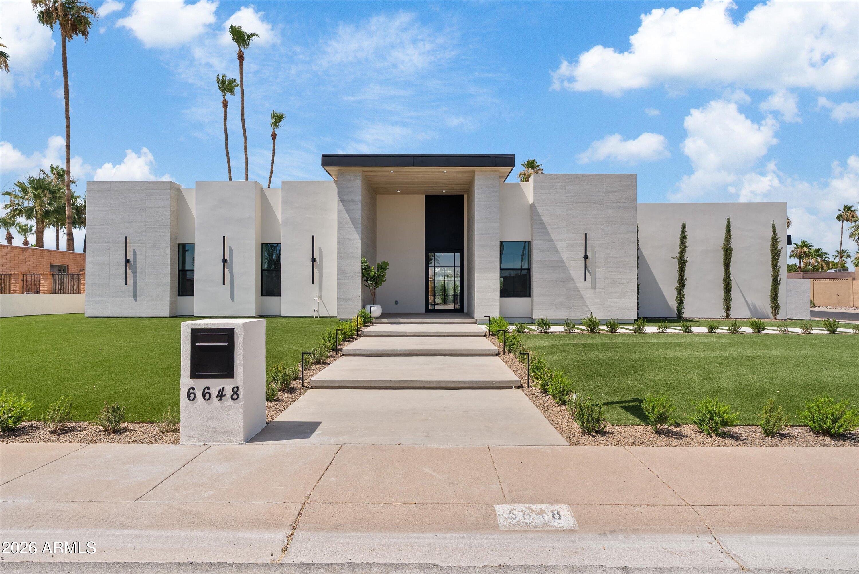 Amazing re-built and redesigned from the ground up in 2025-2026, this exceptional 4-bedroom, 2.5-bath luxury residence is located in Scottsdale's highly sought-after 85254 zip code.
Executed with full permits as an almost entirely new construction masterpiece, this home offers the quality, craftsmanship, and peace of mind of a brand-new custom build. Every detail has been thoughtfully curated by the elite team at Luxury Builts LLC, featuring refined modern finishes, custom millwork, and exceptional attention to detail throughout.
A striking entry welcomes you into an open-concept floor plan with soaring 10-foot ceilings, smooth drywall finishes, wide-plank wood flooring, custom rift white oak doors, and expansive metal sliding glass doors that create seamless indoor-outdoor living. The chef's kitchen features premium Taj Mahal countertops, Thermador refrigeration, a wine fridge, and custom rift white oak cabinetry. Additional highlights include a custom home office beautifully enclosed by a architectural glass wall that functions seamlessly as a sophisticated 4th bedroom or premium workspace, designer closets with integrated LED lighting, and architectural millwork custom manufactured by Luxury Builts.
The resort-style backyard is designed for entertaining, featuring a fully renovated pool, an expansive new ramada, a built-in BBQ, extensive paver hardscaping, synthetic turf, and a flawless smooth stucco exterior finish.
Major structural improvements include all-new framing, a brand-new roof, completely new electrical and plumbing systems, new sewer lines, and a garage completed with durable epoxy flooring.
A rare opportunity to own a nearly new luxury custom home near Scottsdale's premier shopping, dining, and golf.