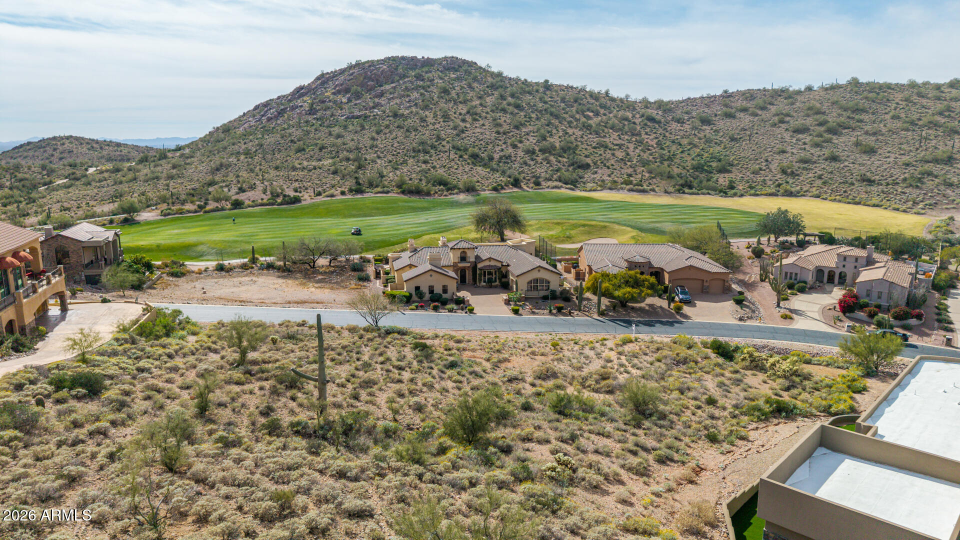 Experience sweeping, elevated views of the iconic Superstition Mountains, surrounding fairways, and glowing city lights from this exceptional homesite in Gold Canyon's exclusive gated community of Vista Del Corazon. Nestled within this private enclave and ideally positioned overlooking the 13th fairway of the renowned Dinosaur Mountain Golf Course, the property is surrounded by stunning custom homes and framed by natural Sonoran Desert vegetation, creating a peaceful yet dramatic setting. The owner has secured architectural design renderings for a custom home concept thoughtfully created for this lot, offering a valuable head start in the design process. Bring your own vision to life or utilize the existing renderings as inspiration to maximize the property's elevation and panoramic views!