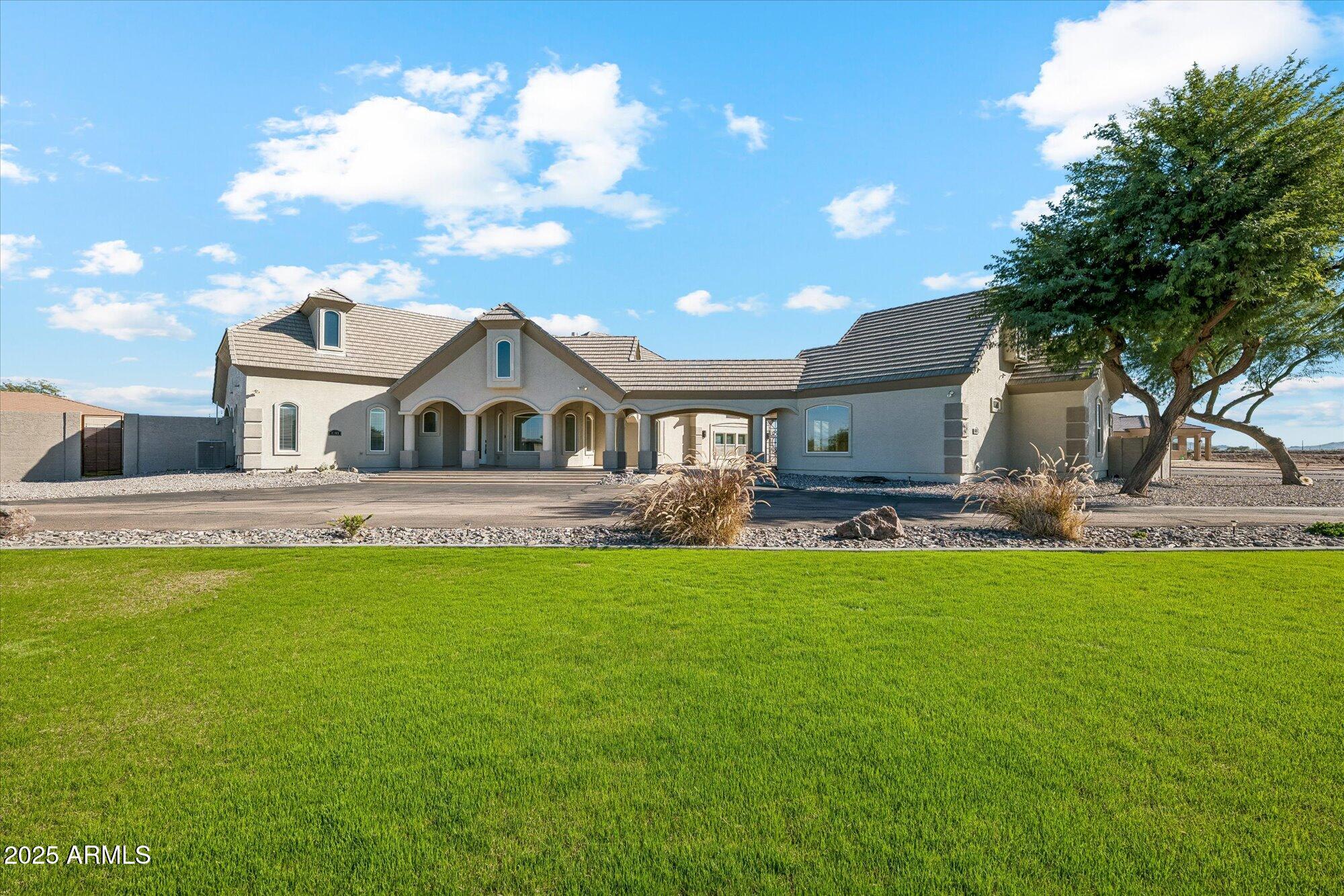 Entertainer's Dream Custom Home + Casita on a 2.3-acre lot! Main house is 3,609 SF 4BR + office + 3 full baths + 2 half baths. 
Upstairs is a game room & living area that leads to a rooftop deck. The chef's kitchen offers granite countertops. The primary suite is on the main level with backyard access and a spa-like ensuite. Fall in love with the 1,000 SF casita featuring a full living area, kitchen, bedroom, gym, bathroom and fenced yard. 
Enjoy a sparkling heated pool, waterfall feature, LED lights, swim up bar, jacuzzi, fire pit, and covered patio.
This horse property features a huge 1,800 SF barn. Horse lovers will appreciate 4 stalls, tack room, grooming bay, beautiful stables, and horse privileges. Private well & ample space to roam. This is a one of a kind and must see property