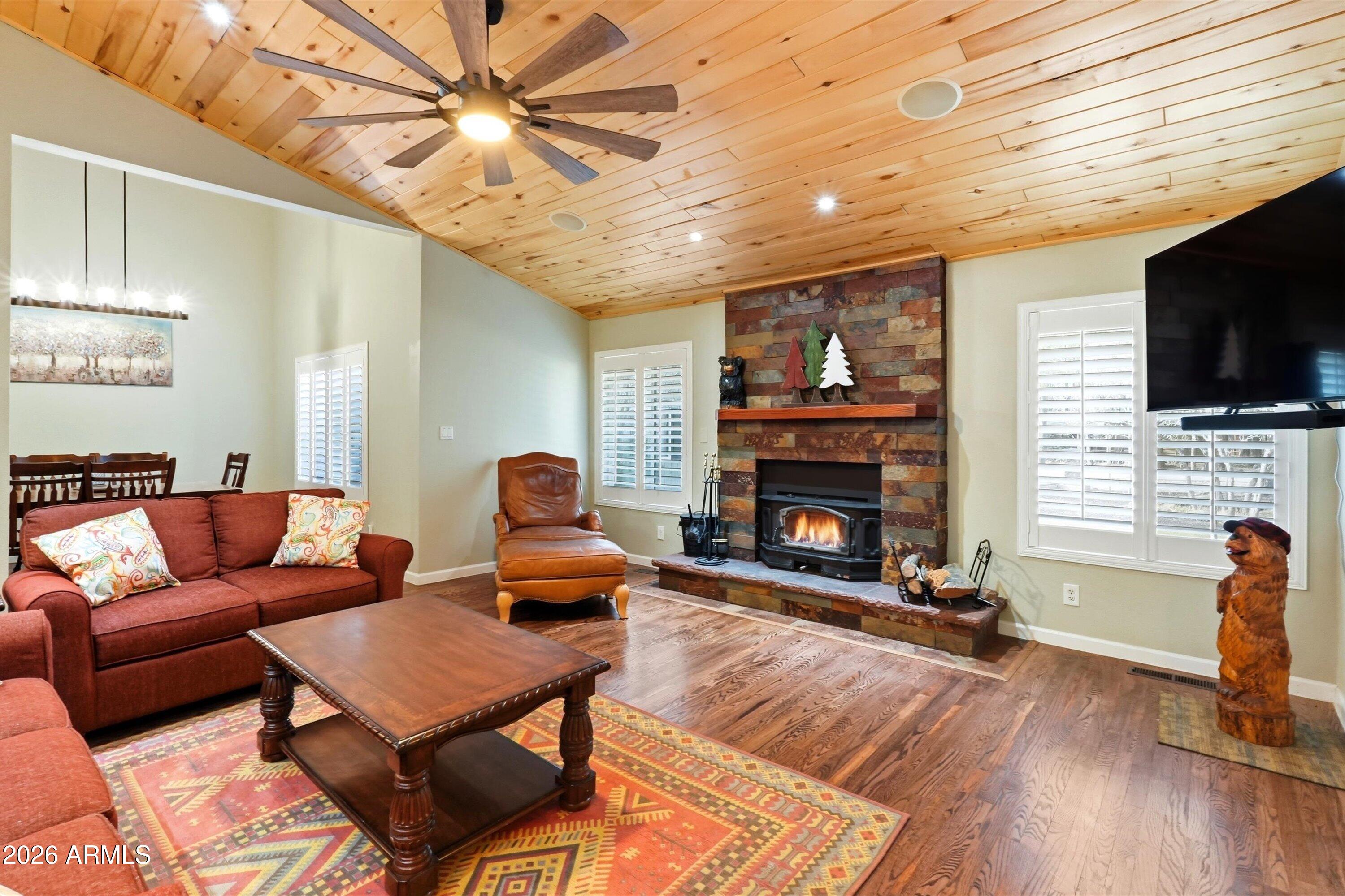 Welcome Home To One Of The Largest Lots In The Pinetop Country Club Neighborhood ...You DO NOT Want To Miss Out On This FULLY FURNISHED Move In Ready Mountain Property! This beautifully remodeled home, situated on a fully fenced 3/4 of an acre lot in Pinetop Country Club, allows for peaceful enjoyment in the Ponderosa Pines. Thoughtfully updated & impeccably maintained, this 4-bedroom, 3-bathroom retreat offers the ideal blend of luxury, comfort, and mountain-town charm. Step inside to an inviting, open layout where the Entertainer's Dream Kitchen takes center stage, complete with double ovens, gas range, farm style sink, upgraded granite/quartz countertops, & custom cabinetry. A custom designed passthrough open to the Living Room, creating the perfect flow for entertaining. Vaulted tongue-and-groove ceilings and a stunning stone fireplace make this space warm and welcoming year-round. Featuring two primary suites, one of which is conveniently located on the main level, & the second located upstairs offering a private balcony, luxurious bathroom, two huge walk-in closets and enough space for a private lounging area or den. Just outside the upstairs primary is a cozy loft retreat perfect for a small hang out area or at home office. In addition, there is a large family room perfect for movie nights or gatherings with direct access to the backyard, you can easily enjoy the indoor/outdoor mountain life. The fully fenced backyard offers two covered patio/deck areas, a gazebo, and multiple areas for games, entertainment, outdoor cooking while enjoying the cool mountain air. The extra-large garage includes built-in storage as well as plenty of space for two cars. In addition to the garage, you have ample space for guest parking (at least 6 additional spots). Recent upgrades include but are not limited to: exterior custom stonework, new roof (2021), Pella Carriage House garage door, water softener, kitchen remodel, flooring replacement, skylight replacement. Come & Enjoy the White Mountain life today!