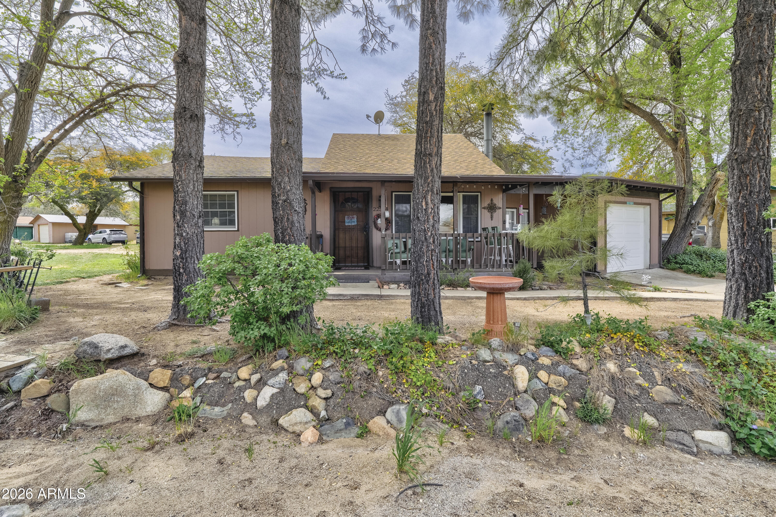 Where the desert breeze meets the mountain air.' Enjoy clean air, blue skies, and the natural beauty of Yarnell from this tastefully restored ranch rambler; set among towering pines. This property includes a 2-bed, 1-bath in the MAIN home PLUS a separate 1-bed, 1-bath CASITA, currently rented and offering excellent short or long-term income potential. Interior updates feature new engineered hardwood floors, a remodeled kitchen and great room, and a new wood-burning fireplace surround.  Whether you're seeking a full-time residence, a weekend escape, or an investment opportunity with built-in rental income, this Yarnell charmer delivers.  With no HOA, nearby schools, and Yarnell's historic downtown, antique shops, trails, and the Shrine just minutes away, this home offers a rare blend of his With no HOA, nearby schools, and Yarnell's historic downtown, antique shops, trails, and the Shrine just minutes away, this home offers a rare blend of history, comfort, and lifestyle appeal with the perfect blend of charm, convenience, and mountain-town living.