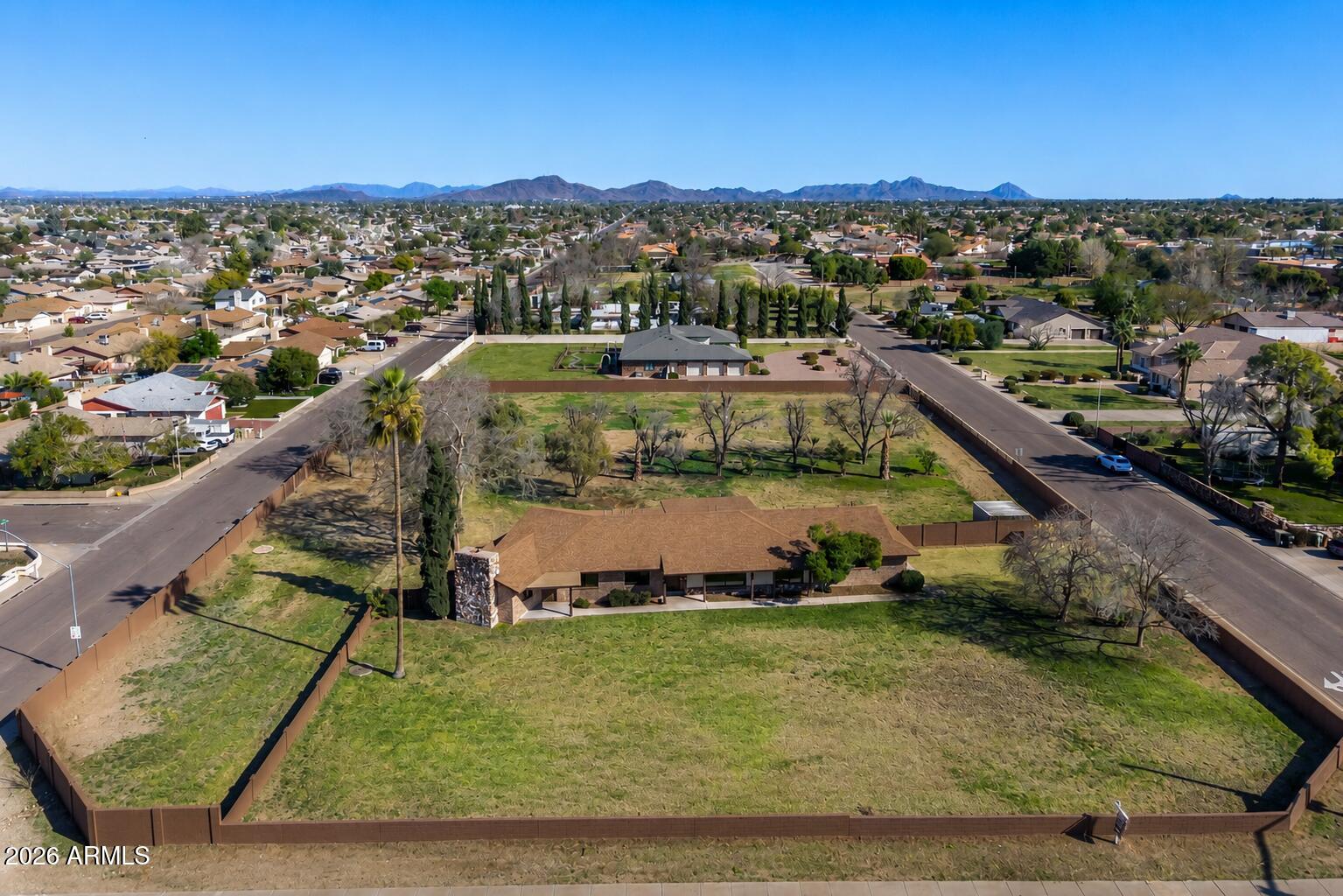 Rarely does a property of this magnitude reach the market—situated on nearly two acres (1.84 Acres / 80,063 Sq. Ft.) of irrigated land with NO HOA. This once-in-a-generation opportunity is the definition of a perfect family compound, offering a massive building envelope with plenty of room to build a second custom home, a professional workshop, or elite RV and fleet storage. The residence itself has been taken down to the studs and thoughtfully redesigned to offer nearly 3,000 sq. ft. of ''like-new'' living space featuring four spacious bedrooms and three modern bathrooms. The gourmet chef's kitchen showcases new wood cabinetry and granite countertops, opening seamlessly to a bright breakfast nook and coffee bar. Every bedroom is filled with natural light, offers a spacious feel, and includes ample closet space. The primary suite is a true retreat, conveniently opening directly to the backyard. Major improvements offer peace of mind, including a new roof, two HVAC units, tankless gas water heater, dual-pane windows, electrical, plumbing, lighting, and spray-foam insulation. Inside, you'll find all-new custom cabinetry throughout the home, luxury vinyl flooring, designer tile, and a massive vaulted bonus room with a wood-burning fireplace and wet barideal for multi-generational living or a home business. For added convenience, the property includes a two-car garage with a large separate storage room perfect for a workshop. Step outside to a covered patio overlooking a lush, park-like backyard kept green by rare irrigation and mature trees. Centrally located near Glendale Community College and ASU West, you're right in the heart of the city with amazing restaurants and shopping nearbyyou can't beat the location. Bring your toys or your businessthe opportunities here are truly endless to make this property your own. With rare A-1 Agricultural zoning and NO HOA or CC&Rs, you have the freedom to bring your horses, goats, and chickens or build your dream compound on this nearly two-acre city oasis (Buyer to verify all zoning, use, and building plans).