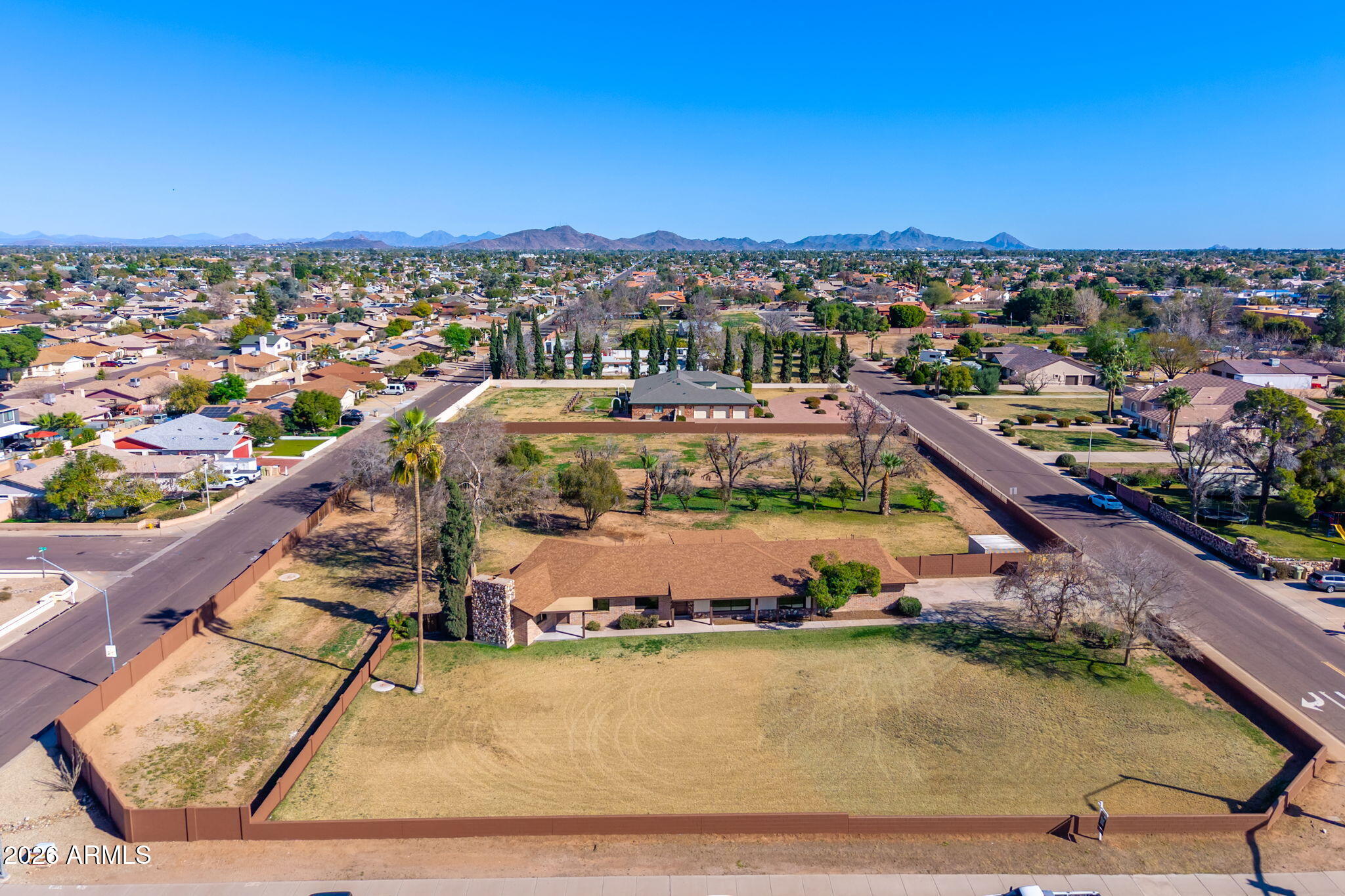 Rarely does a property of this magnitude reach the market—situated on nearly two acres (1.84 Acres / 80,063 Sq. Ft.) of irrigated land with NO HOA. This once-in-a-generation opportunity is the definition of a perfect family compound, offering a massive building envelope with plenty of room to build a second custom home, a professional workshop, or elite RV and fleet storage. The residence itself has been taken down to the studs and thoughtfully redesigned to offer nearly 3,000 sq. ft. of ''like-new'' living space featuring four spacious bedrooms and three modern bathrooms. The gourmet chef's kitchen showcases new wood cabinetry and granite countertops, opening seamlessly to a bright breakfast nook and coffee bar. Every bedroom is filled with natural light, offers a spacious feel, and includes ample closet space. The primary suite is a true retreat, conveniently opening directly to the backyard. Major improvements offer peace of mind, including a new roof, two HVAC units, tankless gas water heater, dual-pane windows, electrical, plumbing, lighting, and spray-foam insulation. Inside, you'll find all-new custom cabinetry throughout the home, luxury vinyl flooring, designer tile, and a massive vaulted bonus room with a wood-burning fireplace and wet barideal for multi-generational living or a home business. For added convenience, the property includes a two-car garage with a large separate storage room perfect for a workshop. Step outside to a covered patio overlooking a lush, park-like backyard kept green by rare irrigation and mature trees. Centrally located near Glendale Community College and ASU West, you're right in the heart of the city with amazing restaurants and shopping nearbyyou can't beat the location. Bring your toys or your businessthe opportunities here are truly endless to make this property your own. With rare A-1 Agricultural zoning and NO HOA or CC&Rs, you have the freedom to bring your horses, goats, and chickens or build your dream compound on this nearly two-acre city oasis (Buyer to verify all zoning, use, and building plans).